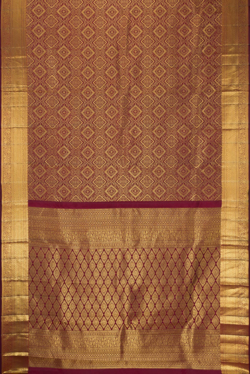 Flat view of Maroon Dual Tone Kanchipuram Silk Saree with Zari Brocade on the body and Zari Border. 