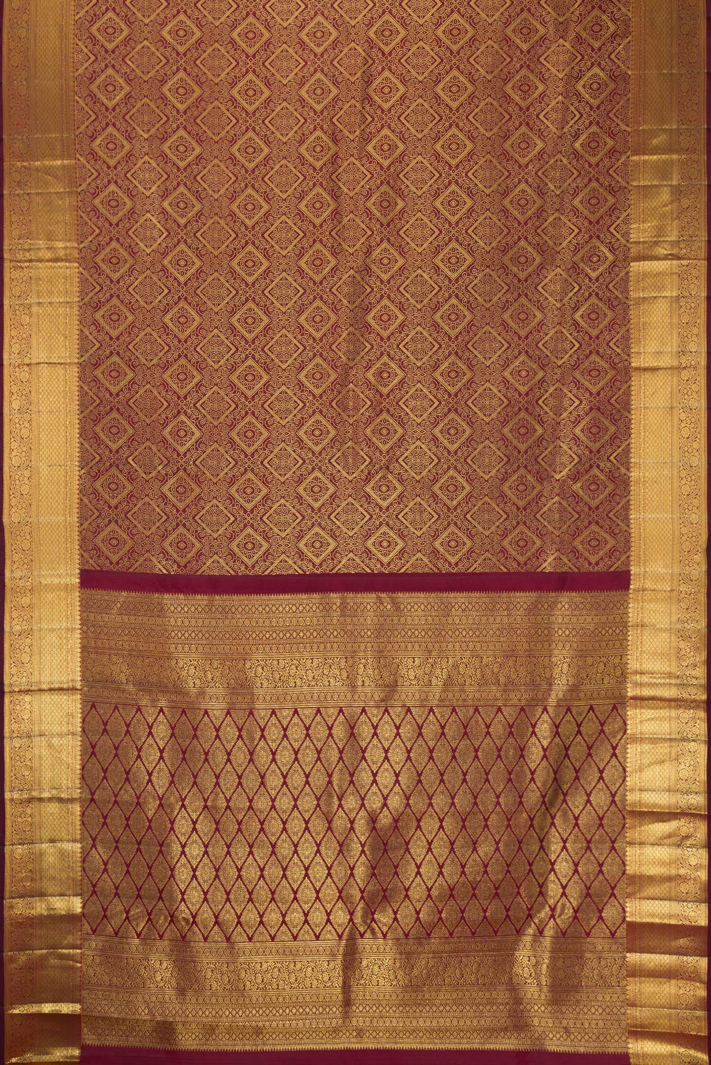 Flat view of Maroon Dual Tone Kanchipuram Silk Saree with Zari Brocade on the body and Zari Border. 