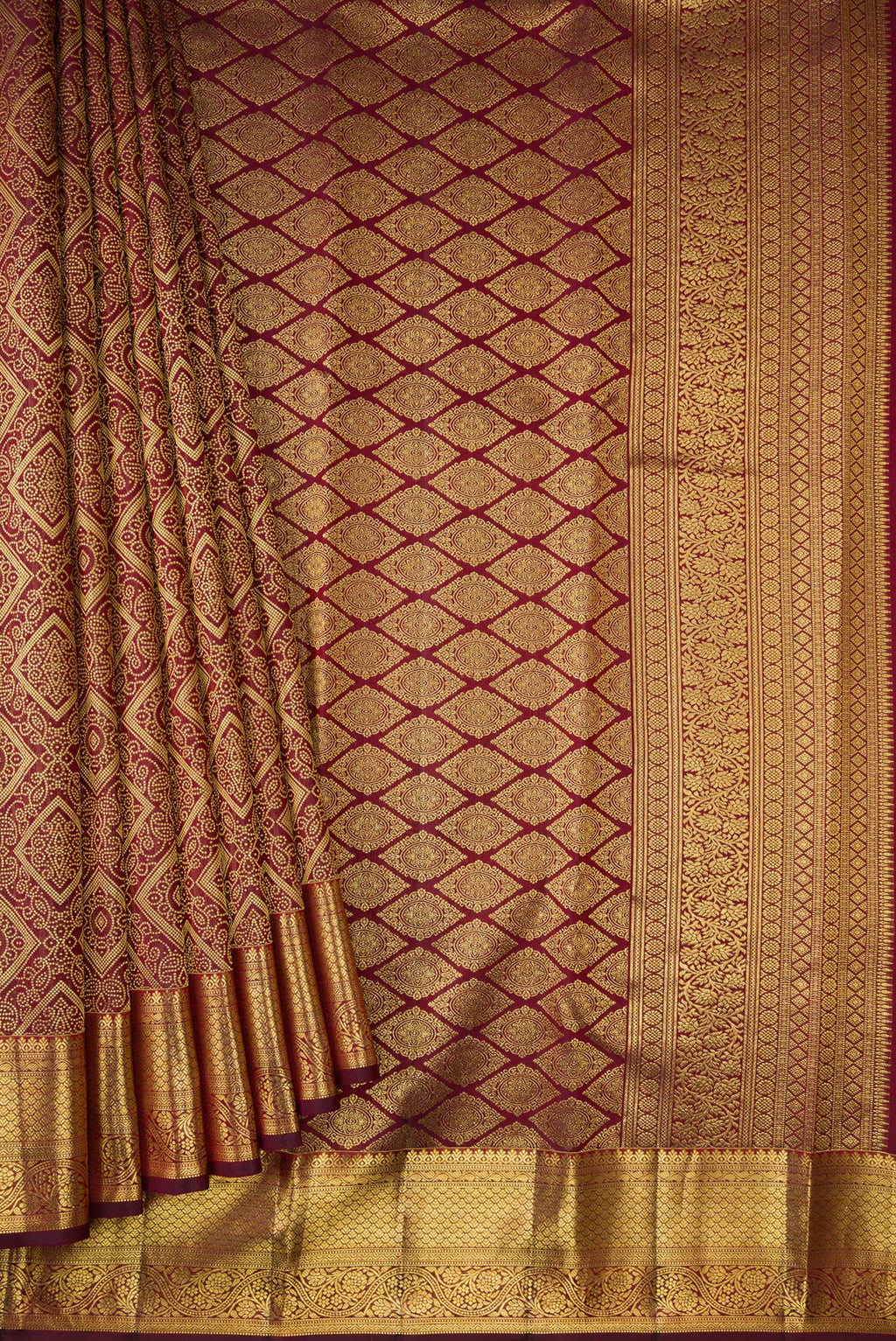 Pleats and pallu of Maroon Dual Tone Kanchipuram Silk Saree with Zari Brocade on the body and Zari Border. 
