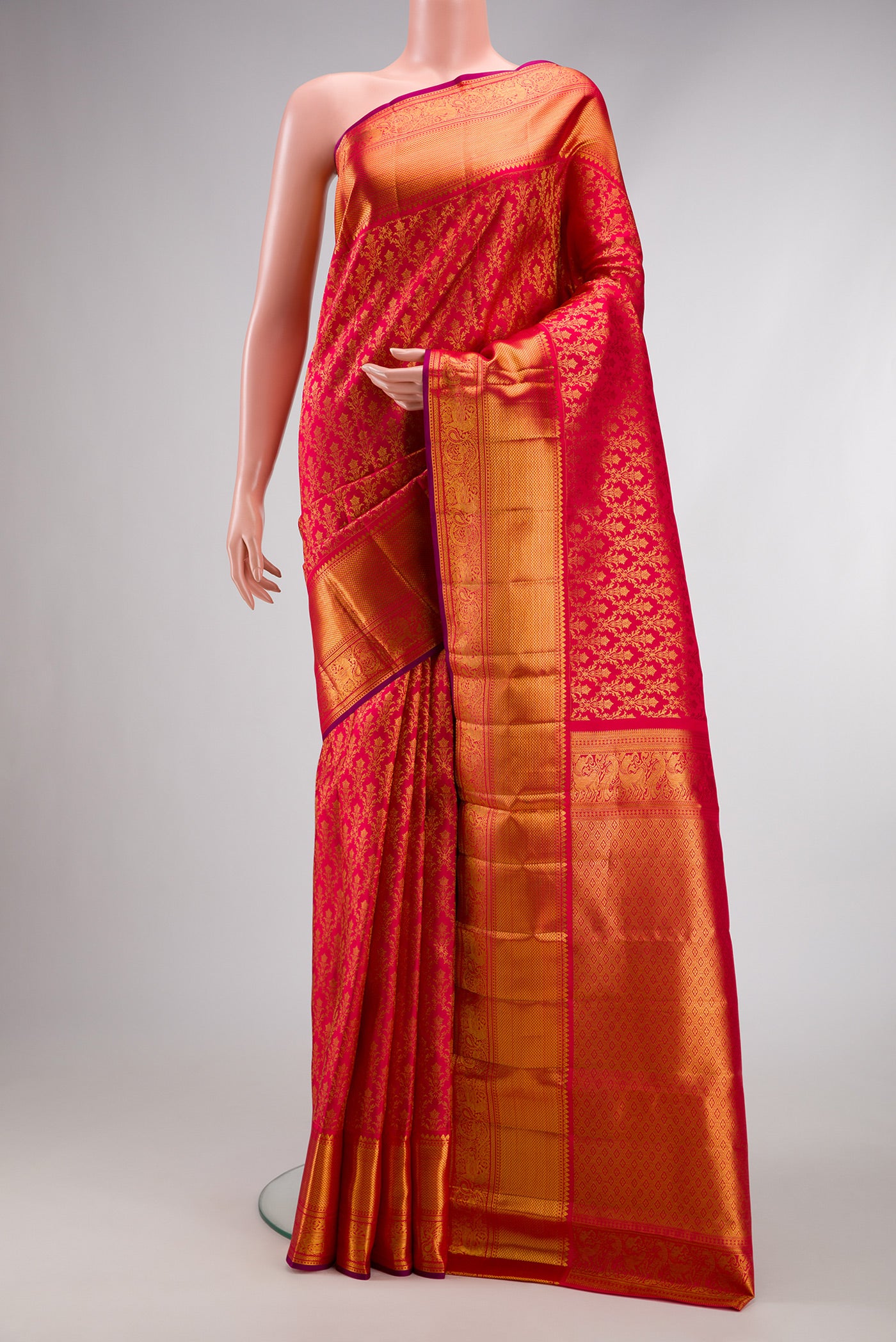 Red Dual Tone Kanchipuram Silk Saree with Zari Brocade on the body and Zari Border.  displayed on a mannequin