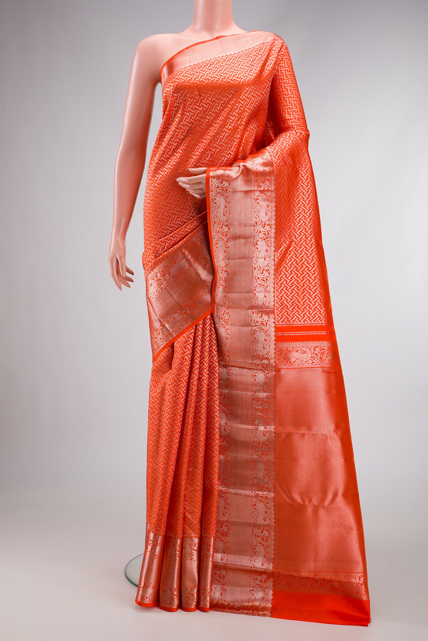 Orange Dual Tone Kanchipuram Silk Saree with Zari Brocade on the body and Zari Border.  displayed on a mannequin