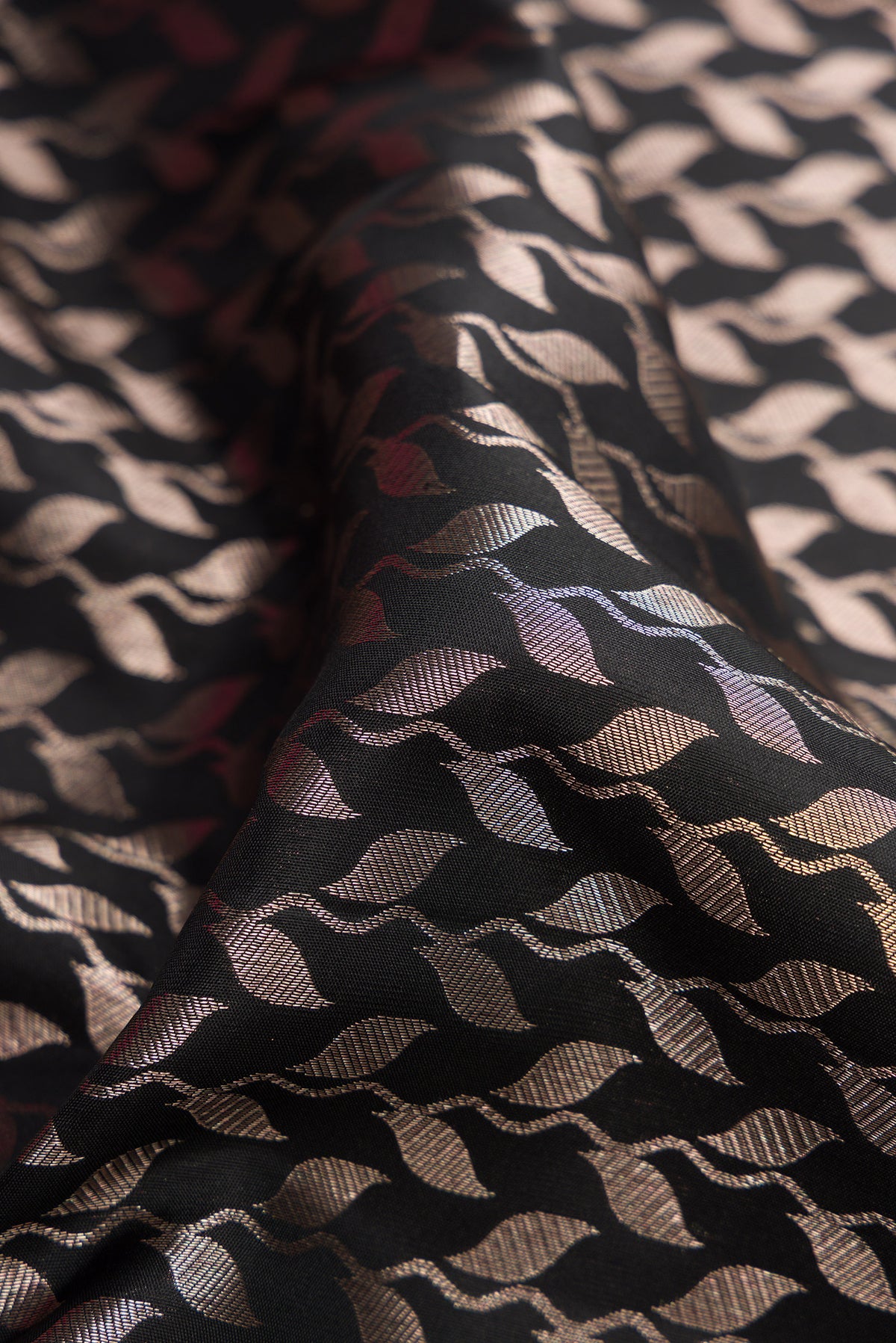 Close up of Black Dual Tone Kanchipuram Silk Saree with Zari Brocade on the body and Zari Border.  displaying folds
