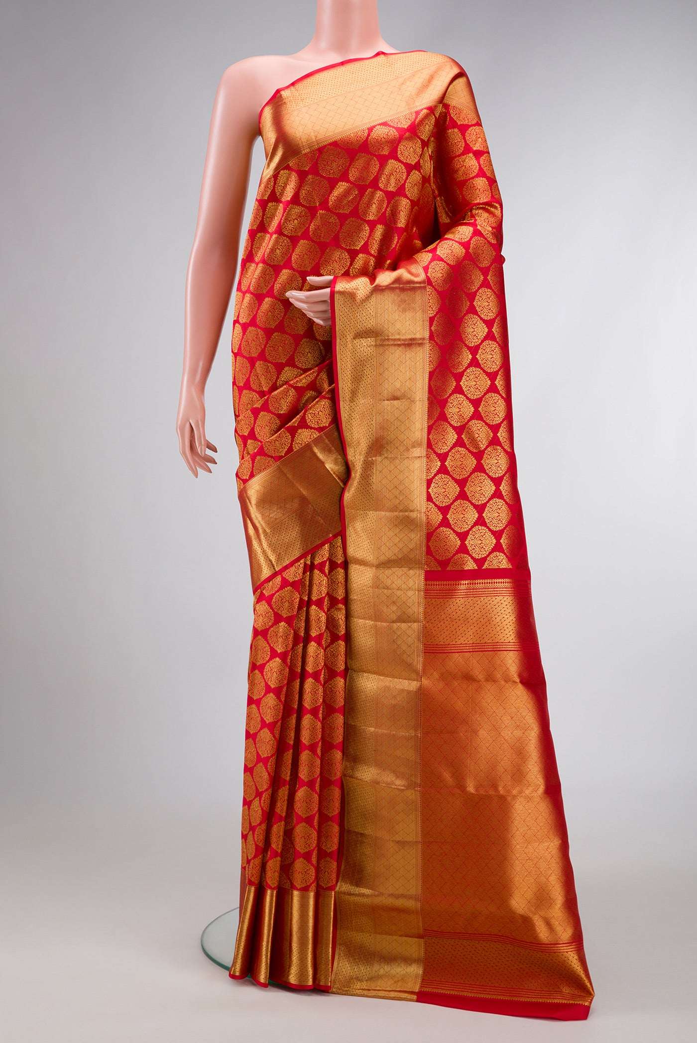 Red Dual Tone Kanchipuram Silk Saree with Zari Brocade on the body and Zari Border.  displayed on a mannequin