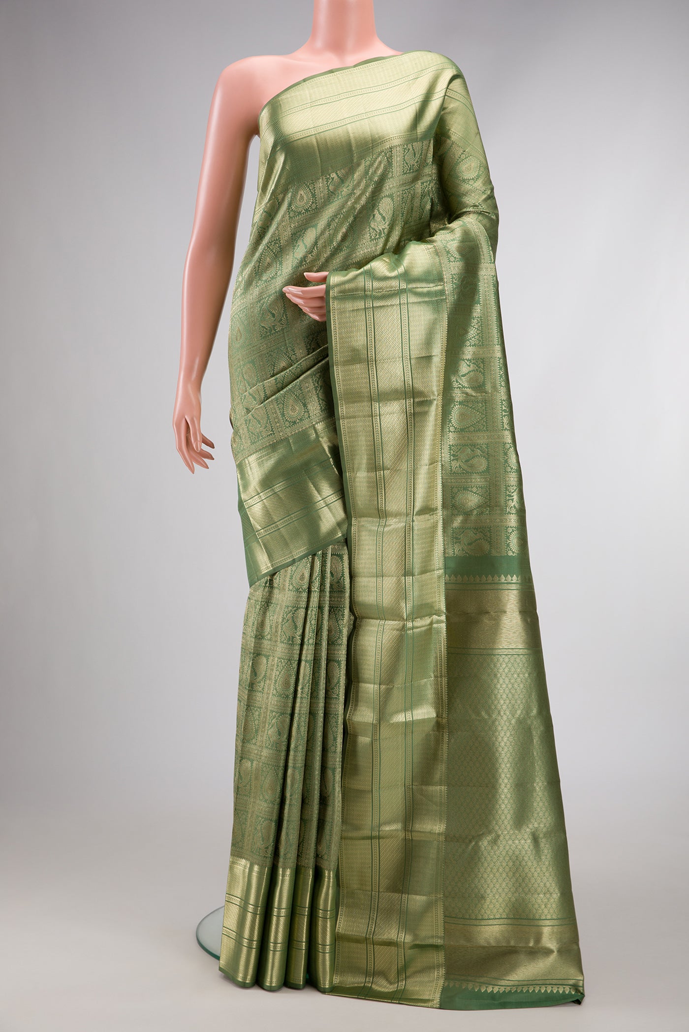 Pista Green Dual Tone Kanchipuram Silk Saree with Zari Brocade on the body and Zari Border.  displayed on a mannequin