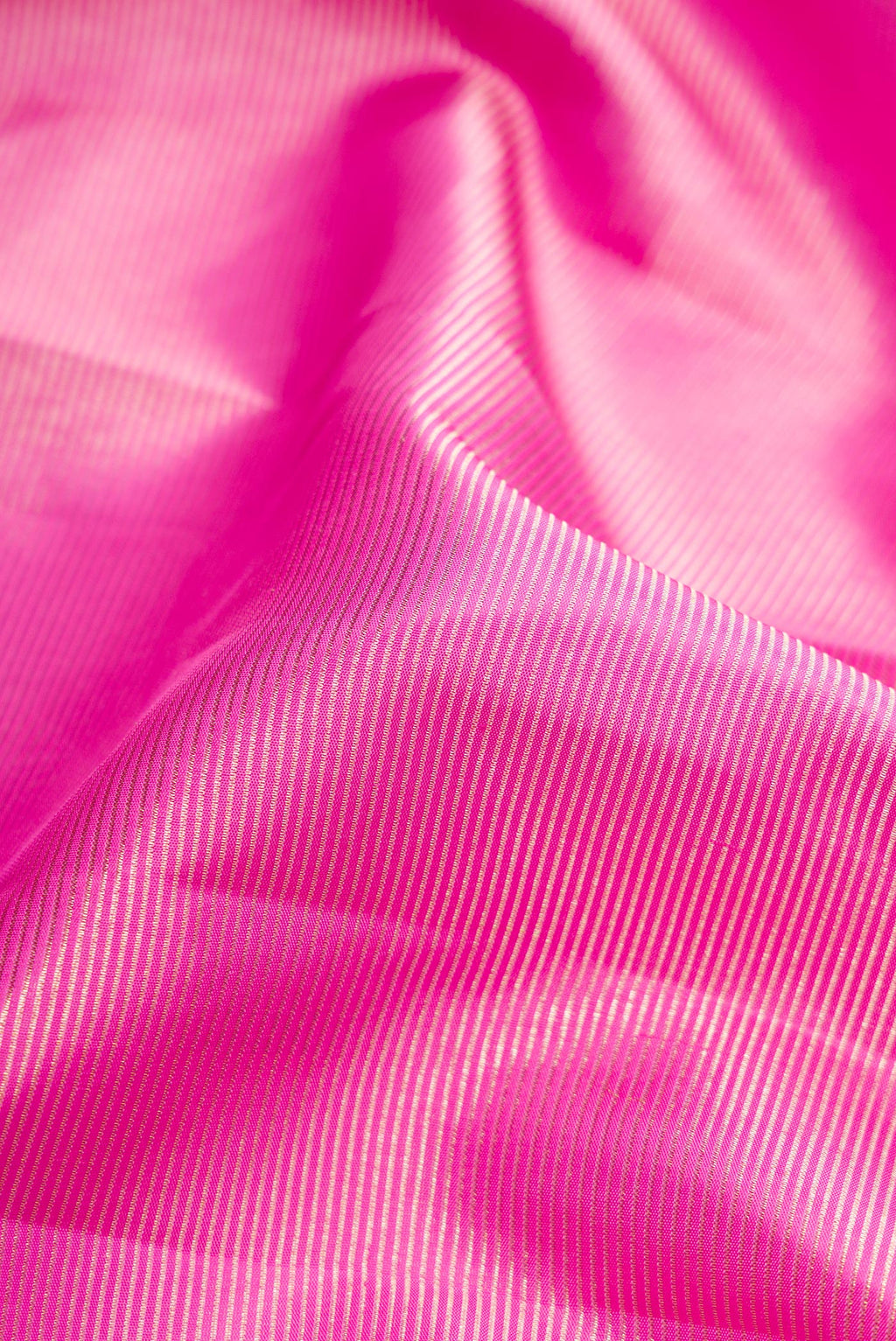 Close up of Pink Dual Tone Kanchipuram Silk Saree with Zari Brocade on the body and Zari Border.  displaying folds