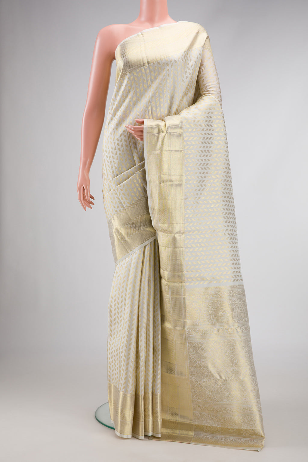 Off White Dual Tone Kanchipuram Silk Saree with Zari Brocade on the body and Zari Border.  displayed on a mannequin