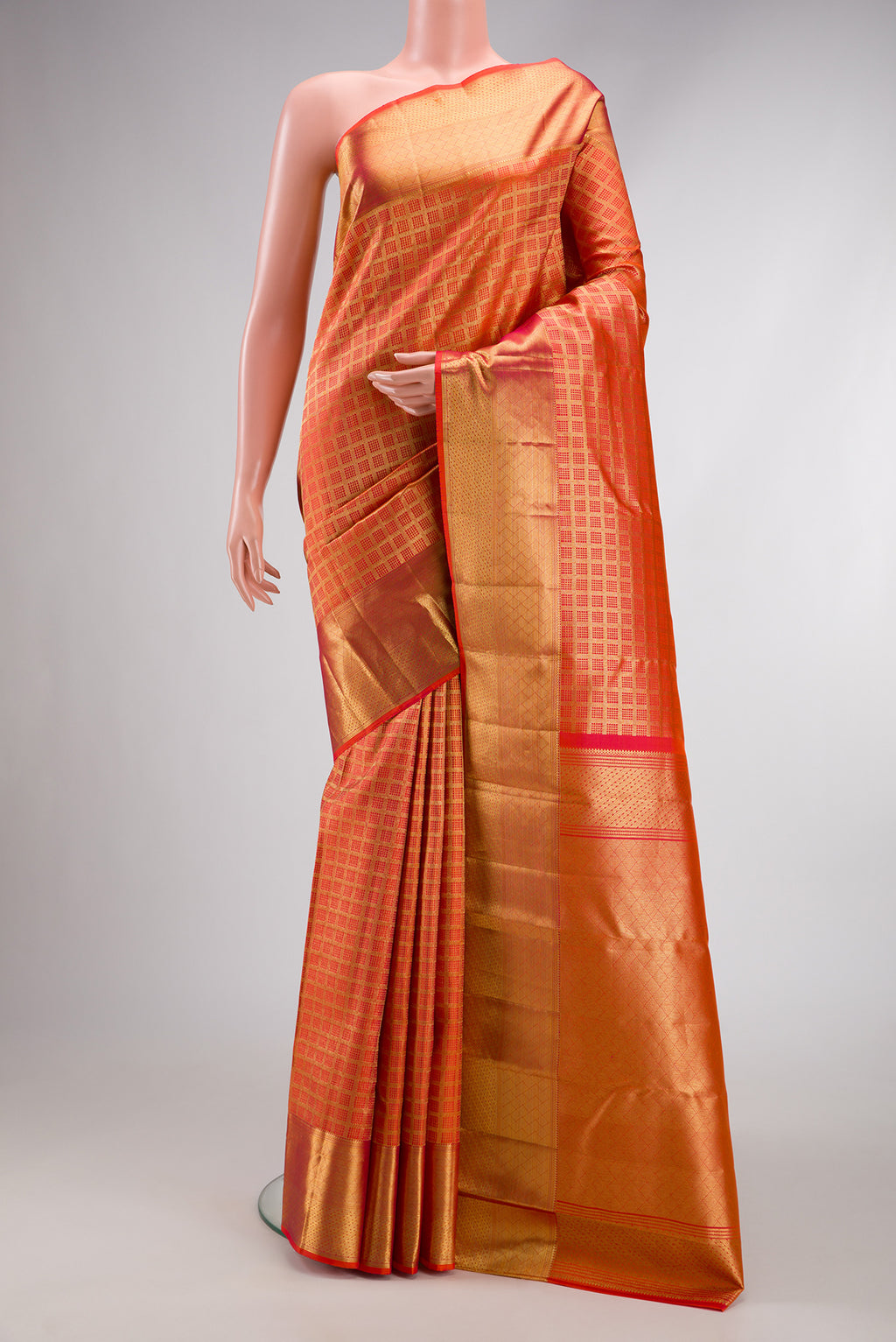 Orange Dual Tone Kanchipuram Silk Saree with Checked design on the body and Zari Border.  displayed on a mannequin