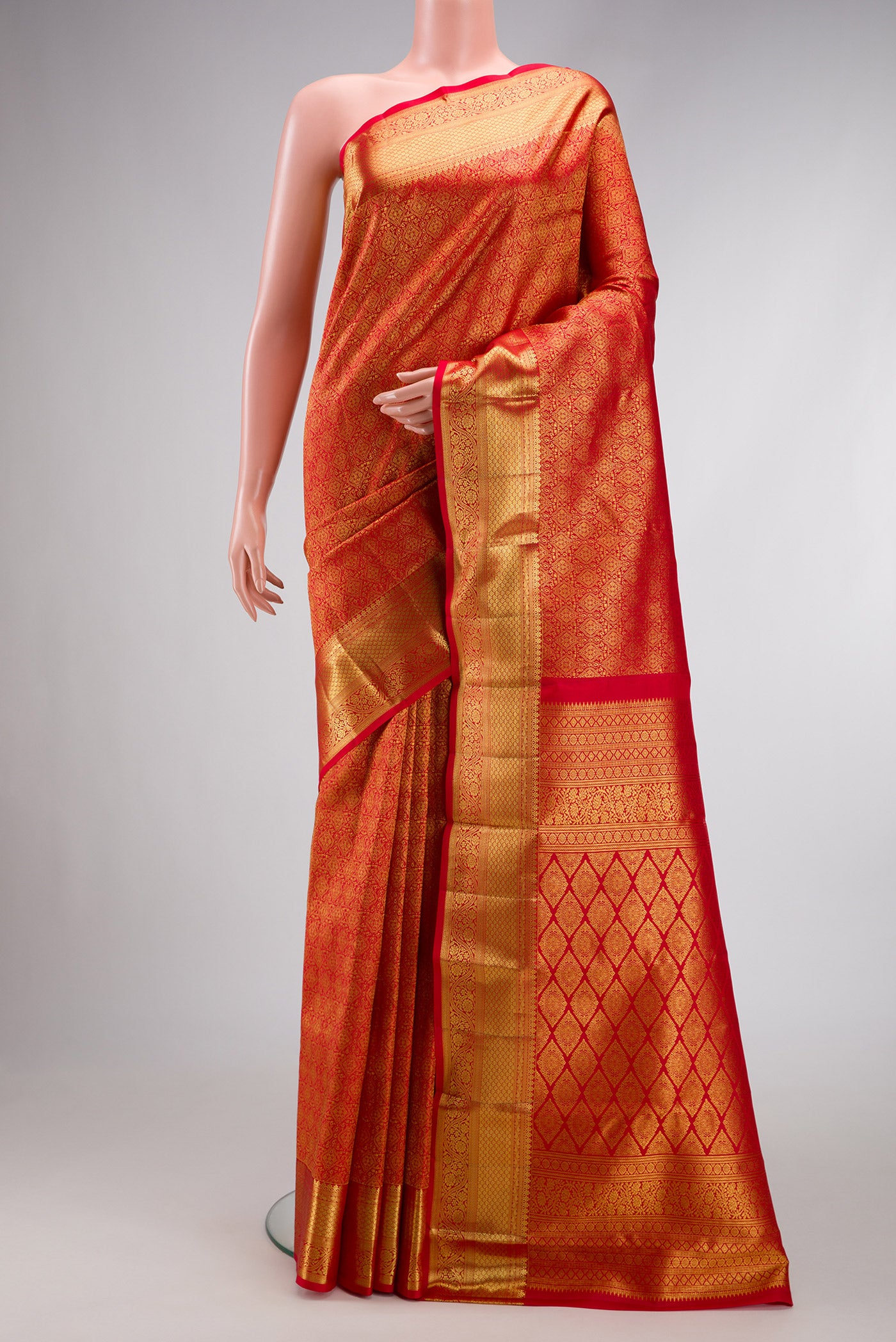 Red Dual Tone Kanchipuram Silk Saree with Zari Brocade on the body and Zari Border.  displayed on a mannequin