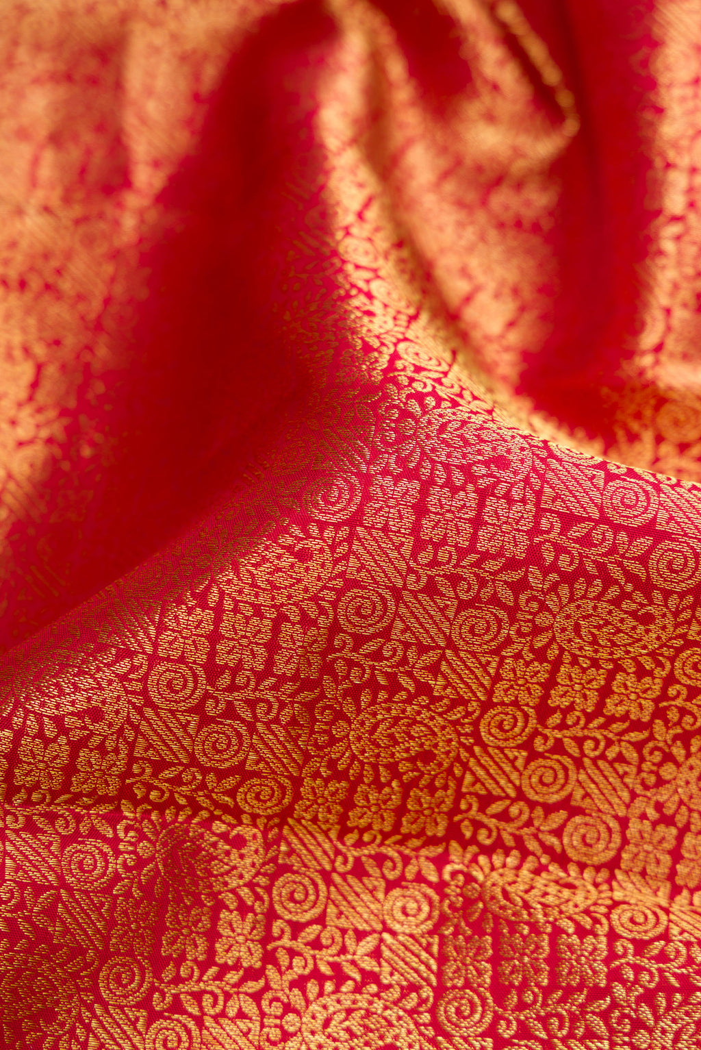 Close up of Maroon Dual Tone Kanchipuram Silk Saree with Zari Brocade on the body and Zari Border.  displaying folds
