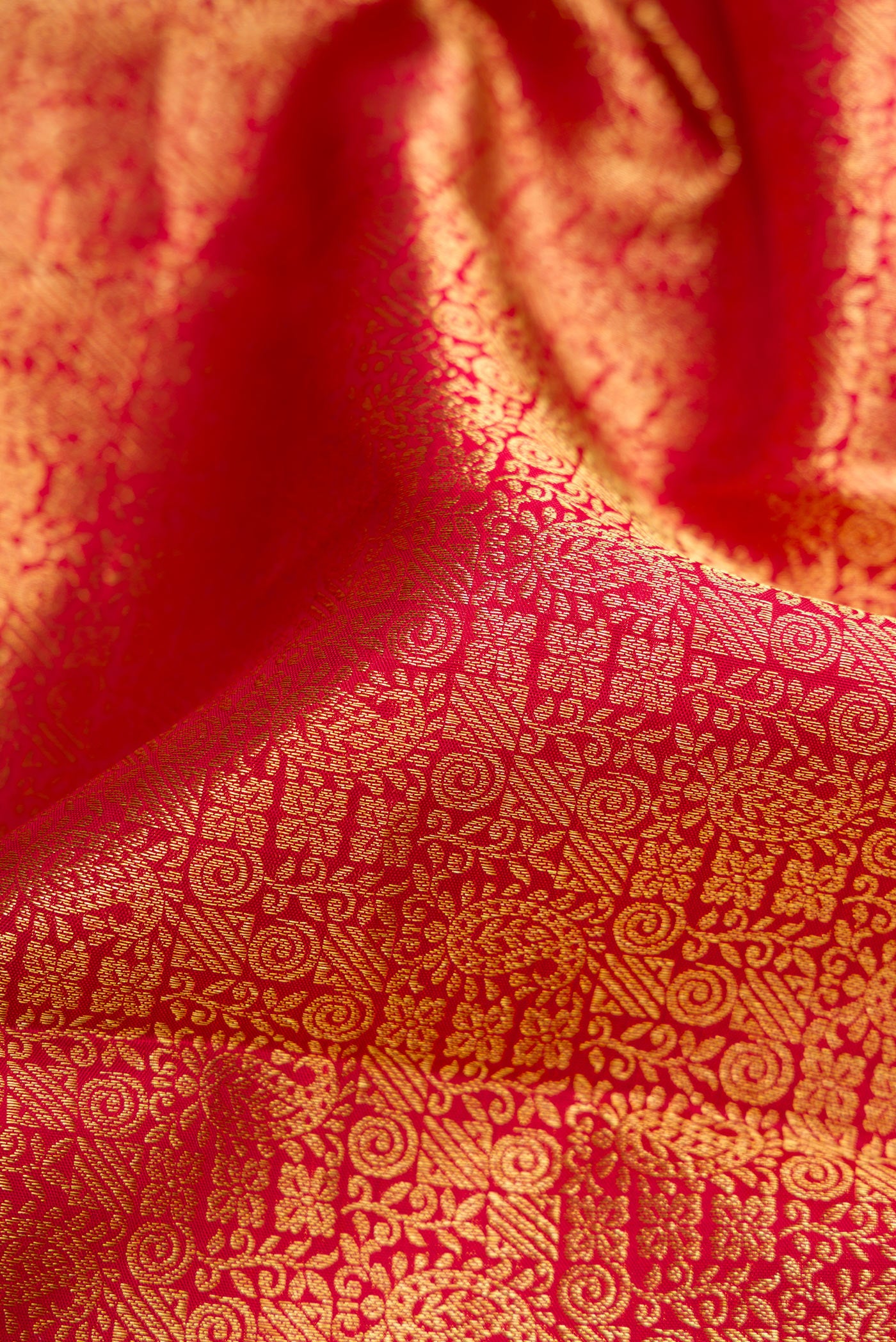 Close up of Maroon Dual Tone Kanchipuram Silk Saree with Zari Brocade on the body and Zari Border.  displaying folds