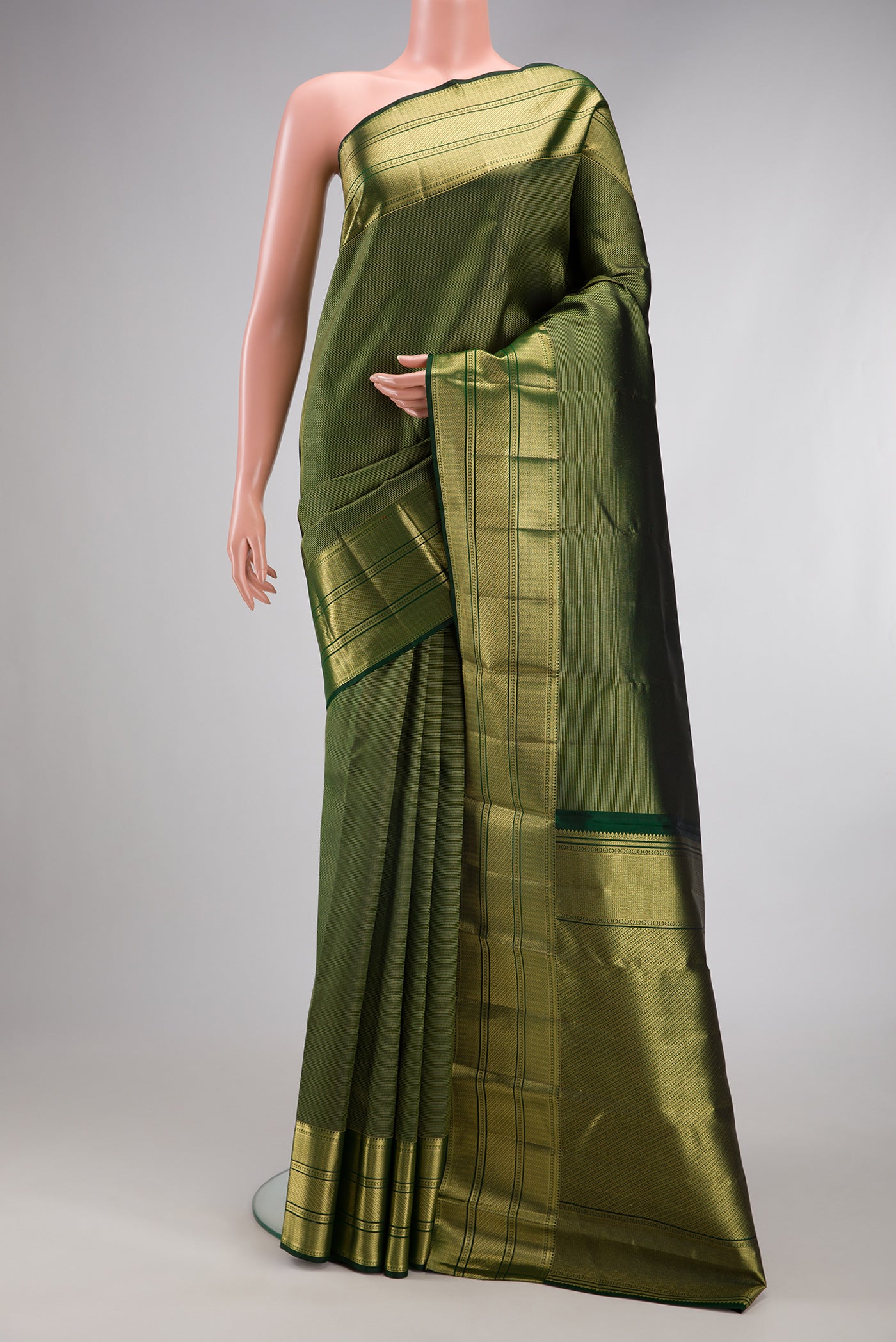 Bottle Green Kanchipuram Silk Saree with Zari Brocade on the body and Fancy Border.  displayed on a mannequin