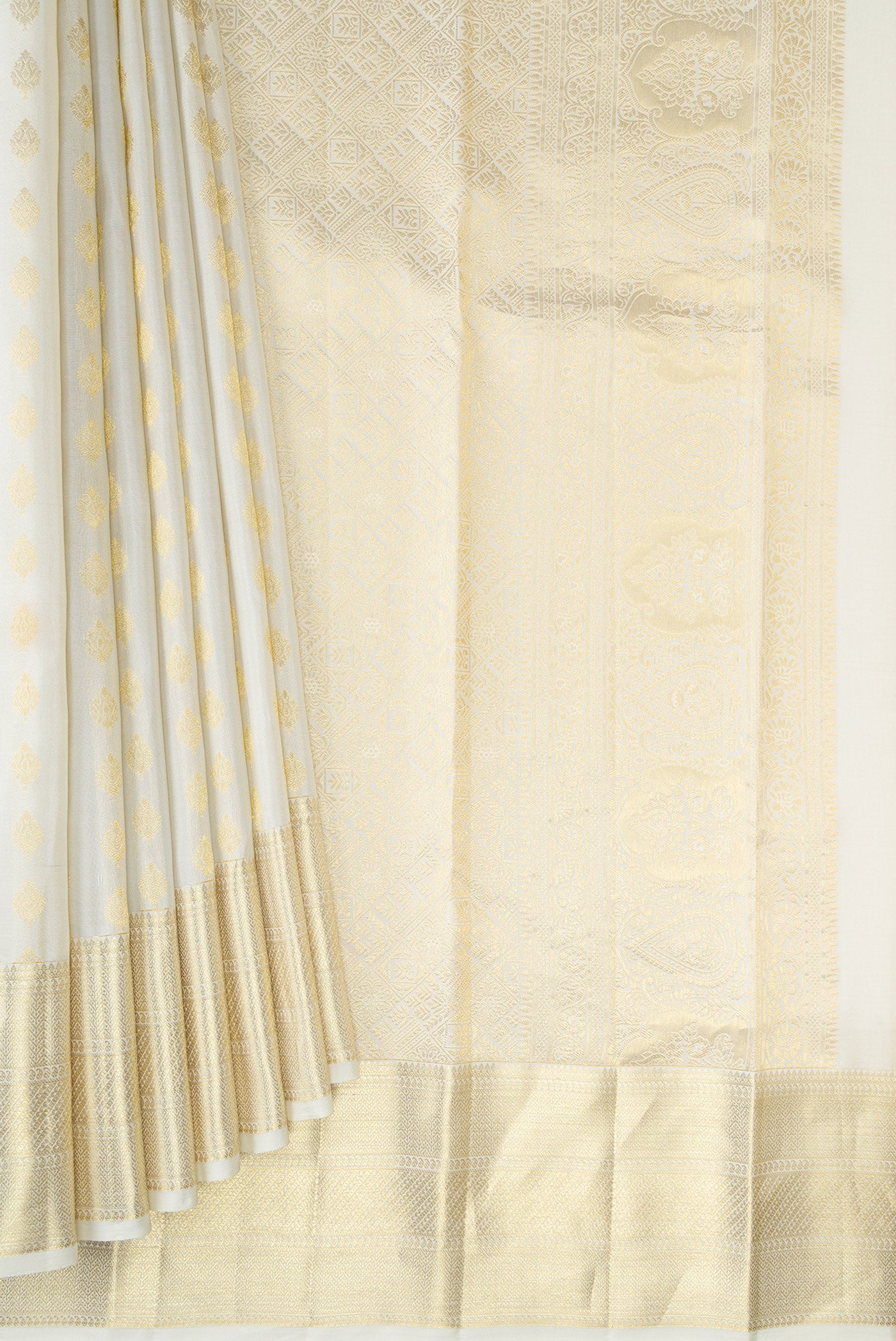 Pleats and pallu of Off White Kanchipuram Silk Saree with Zari Butta on the body and Zari Border. 