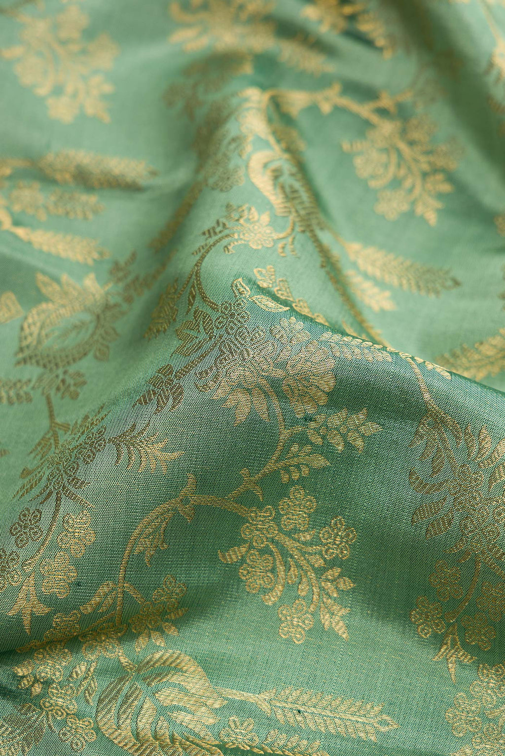 Close up of Mehandi Green Dual Tone Kanchipuram Silk Saree with Zari Brocade on the body and Zari Border.  displaying folds