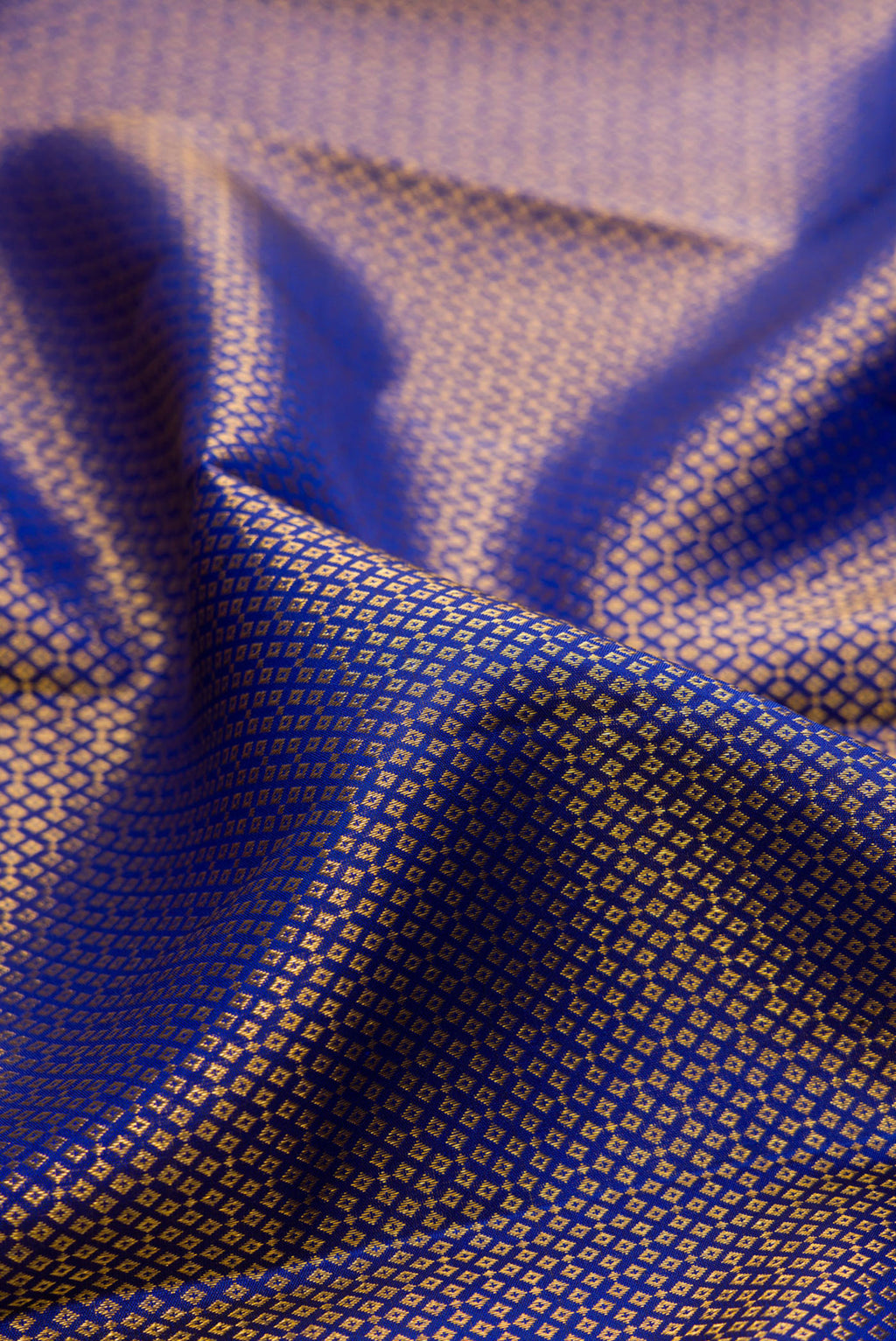 Close up of Royal Blue Kanchipuram Silk Saree with Zari Brocade on the body and Zari Border.  displaying folds