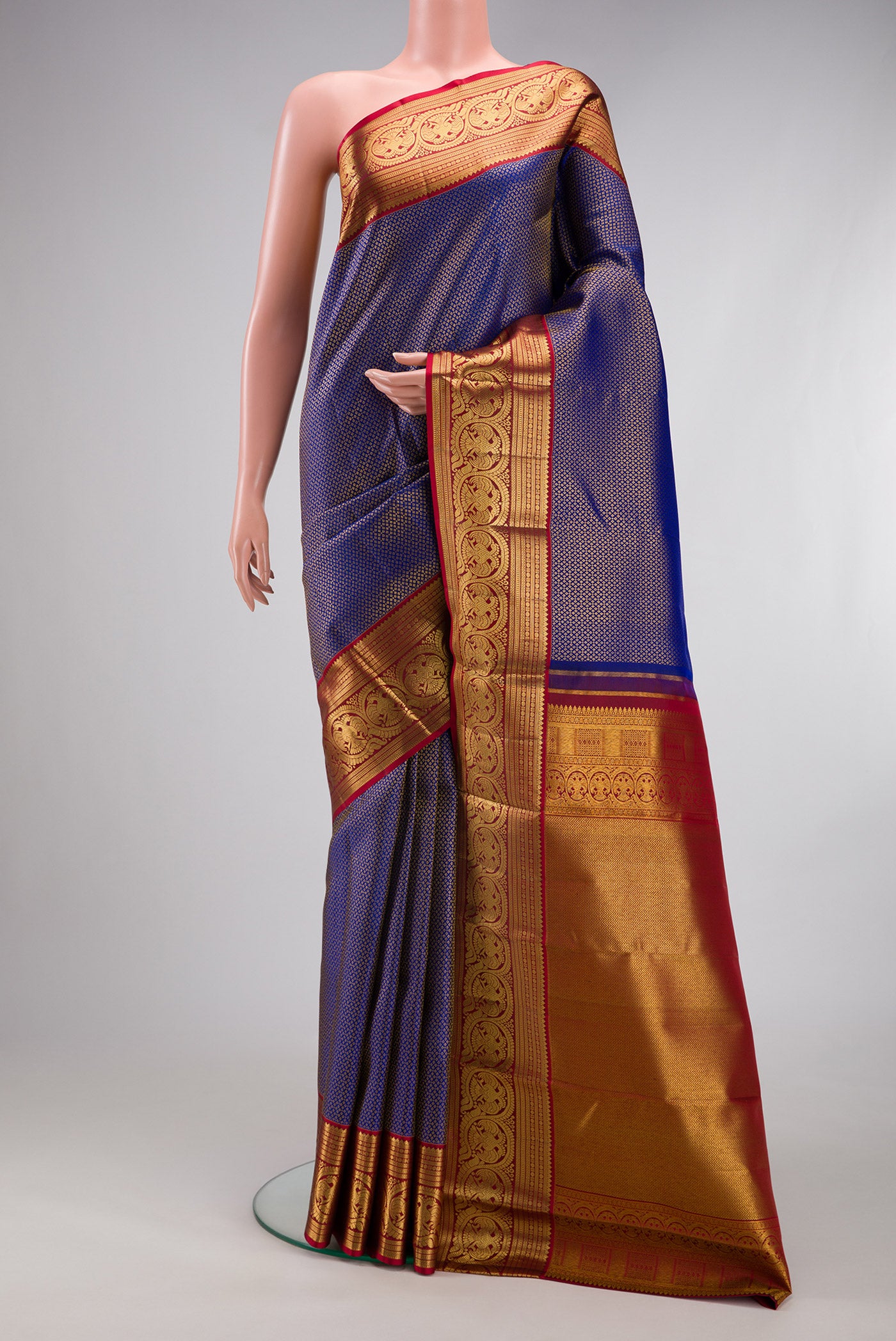 Royal Blue Kanchipuram Silk Saree with Zari Brocade on the body and Zari Border.  displayed on a mannequin