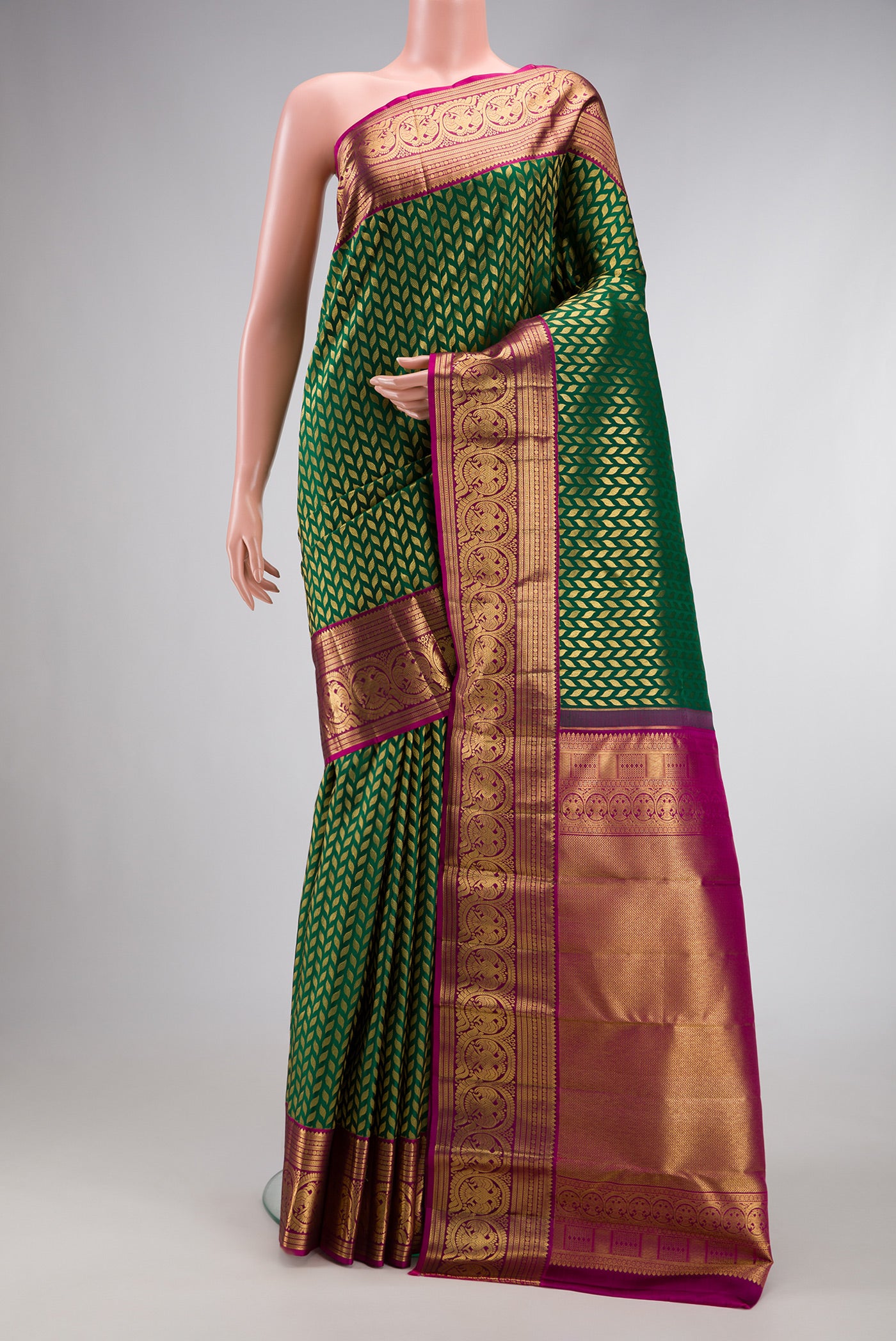 Bottle Green Dual Tone Kanchipuram Silk Saree with Zari Brocade on the body and Zari Border.  displayed on a mannequin