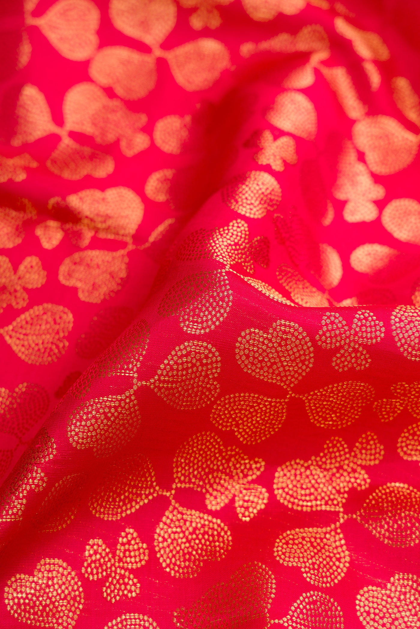 Close up of Dark Pink Dual Tone Kanchipuram Silk Saree with Zari Brocade on the body and Zari Border.  displaying folds