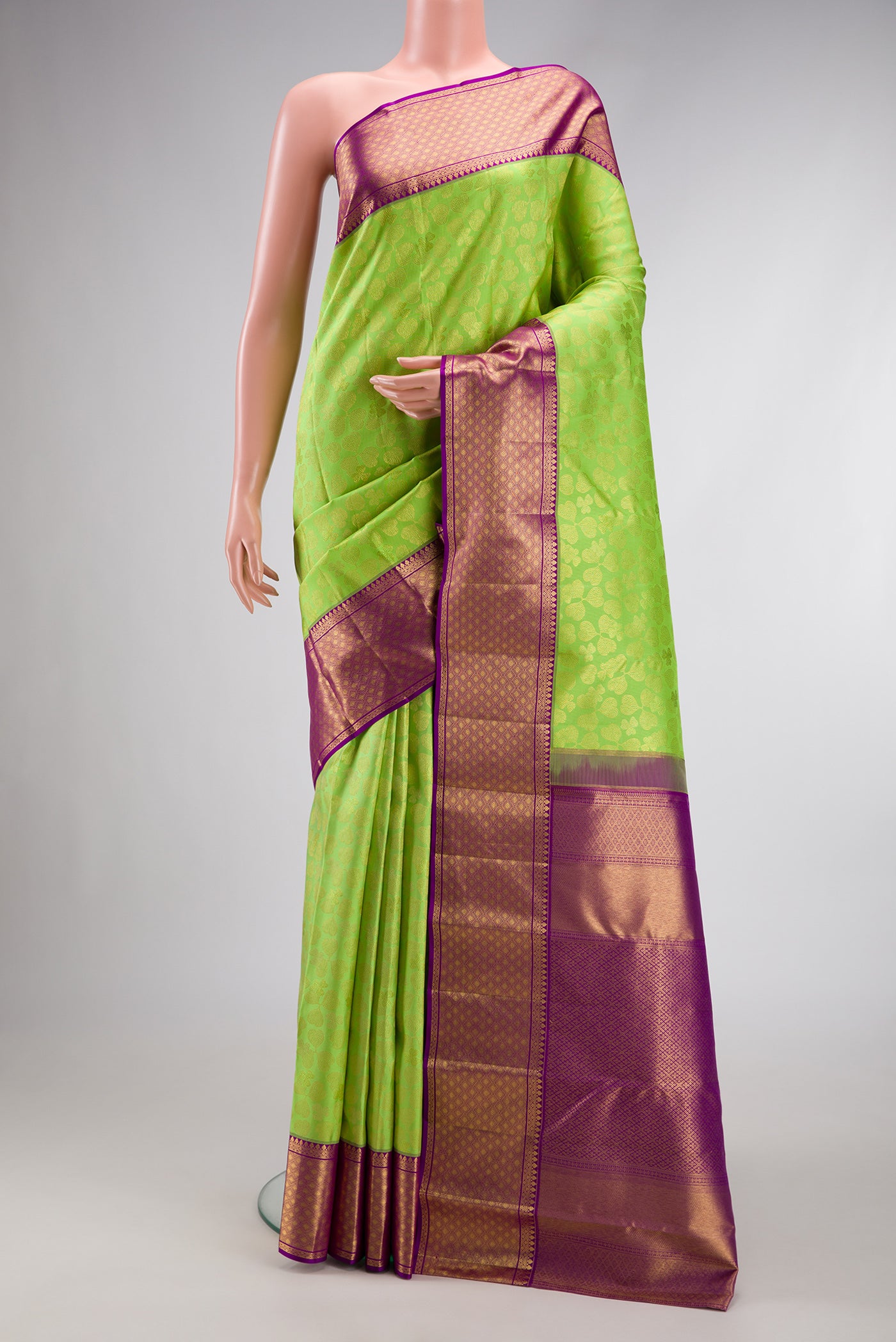 Parrot Green Dual Tone Kanchipuram Silk Saree with Zari Brocade on the body and Zari Border.  displayed on a mannequin