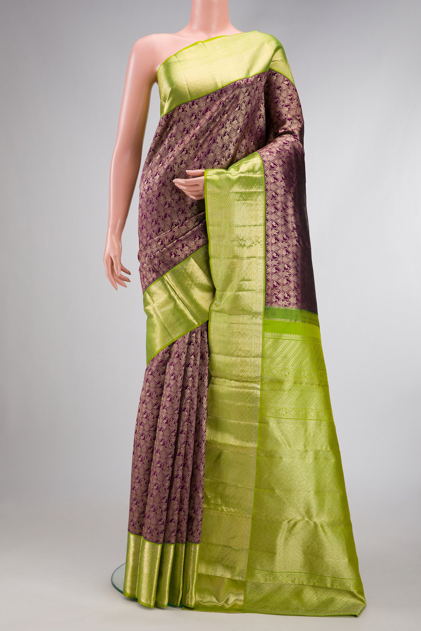 Magenta Dual Tone Kanchipuram Silk Saree with Zari Brocade on the body and Zari Border.  displayed on a mannequin