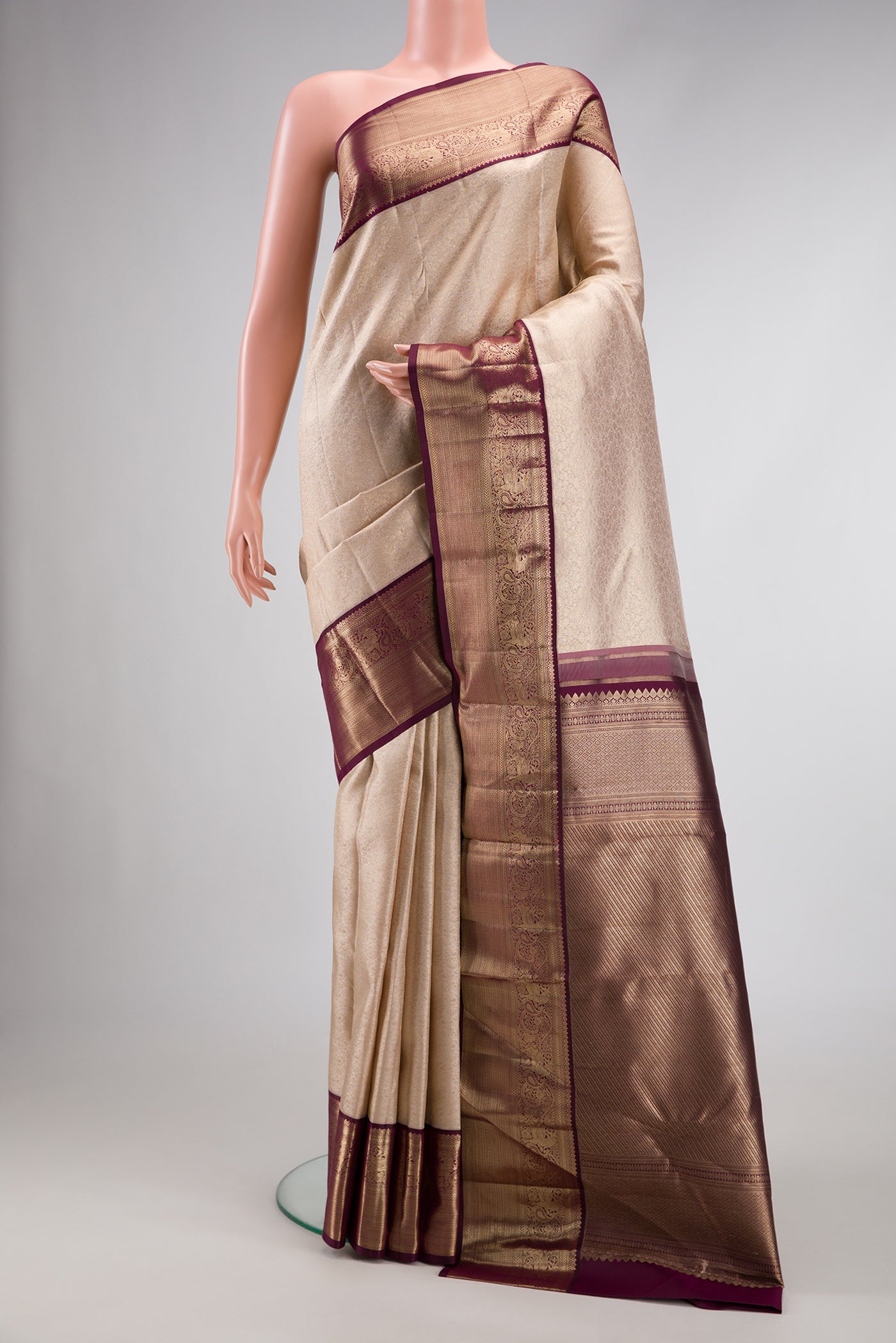Brown Dual Tone Kanchipuram Silk Saree with Zari Brocade on the body and Zari Border.  displayed on a mannequin