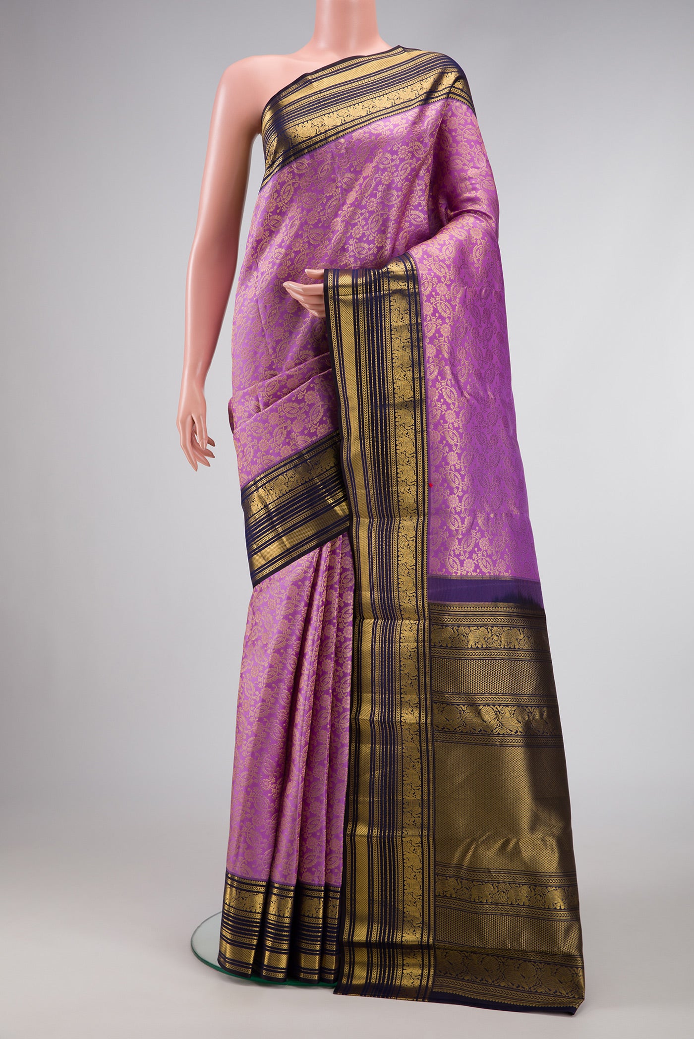 Lavender Dual Tone Kanchipuram Silk Saree with Zari Brocade on the body and Zari Border.  displayed on a mannequin