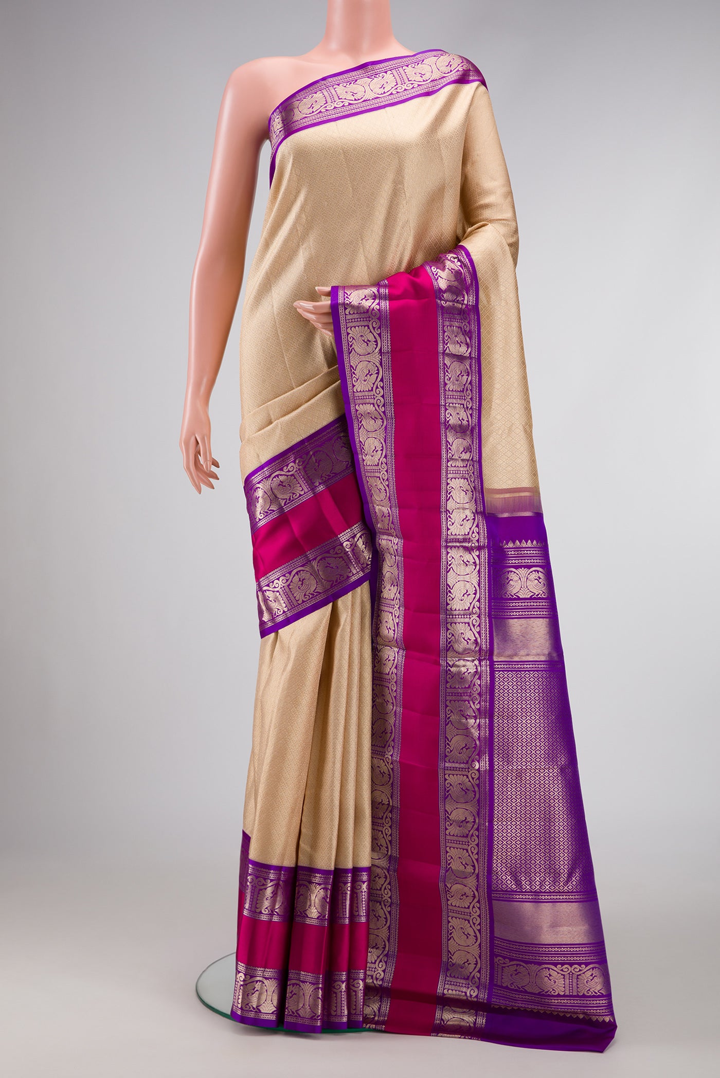 Beige Dual Tone Kanchipuram Silk Saree with Zari Brocade on the body and Zari Border.  displayed on a mannequin