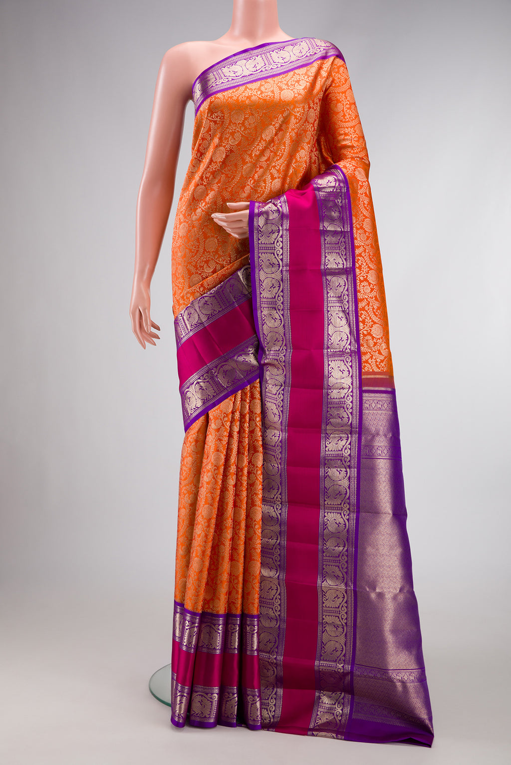 Orange Dual Tone Kanchipuram Silk Saree with Zari Brocade on the body and Zari Border.  displayed on a mannequin