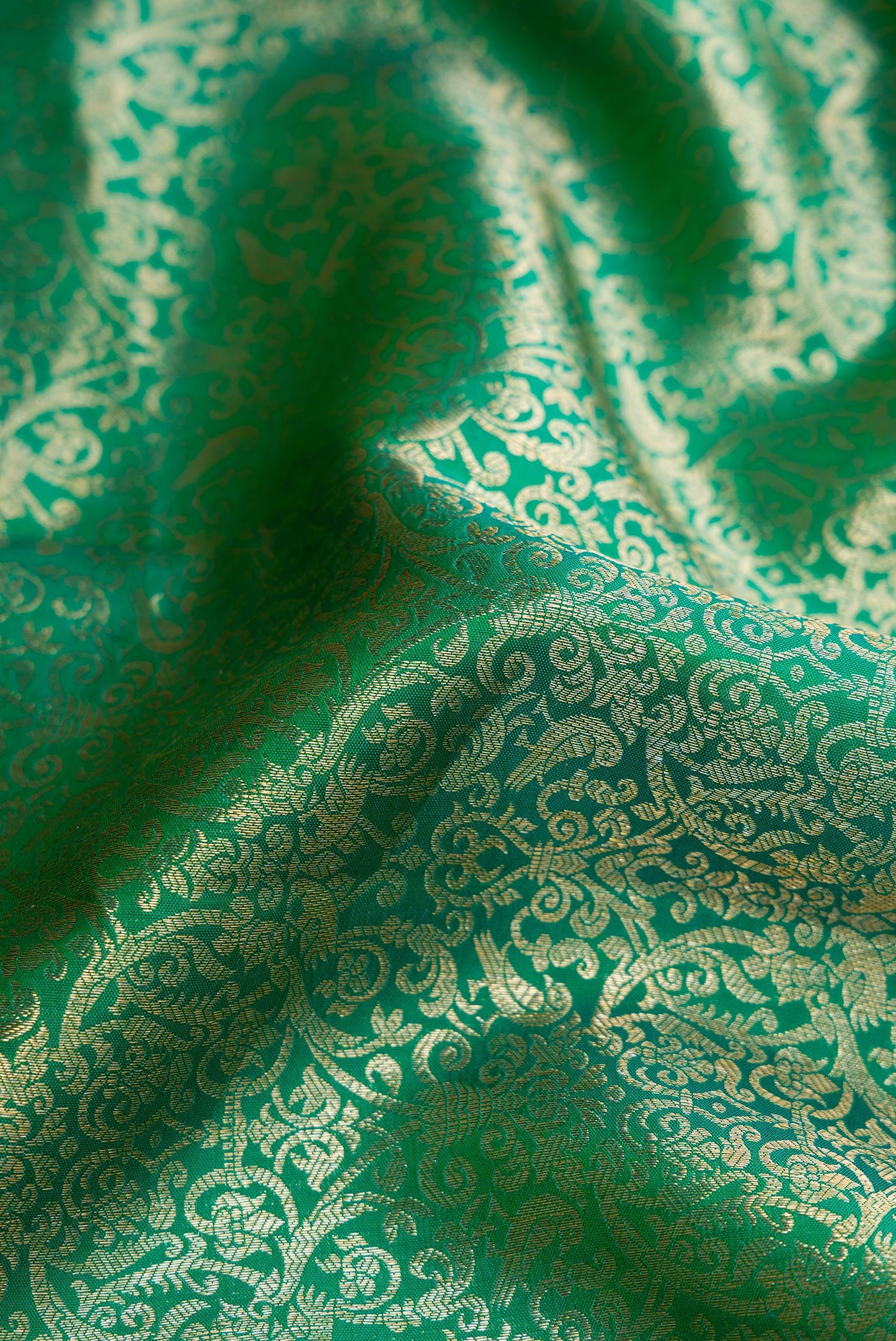 Close up of Sea Green Dual Tone Kanchipuram Silk Saree with Zari Brocade on the body and Zari Border.  displaying folds