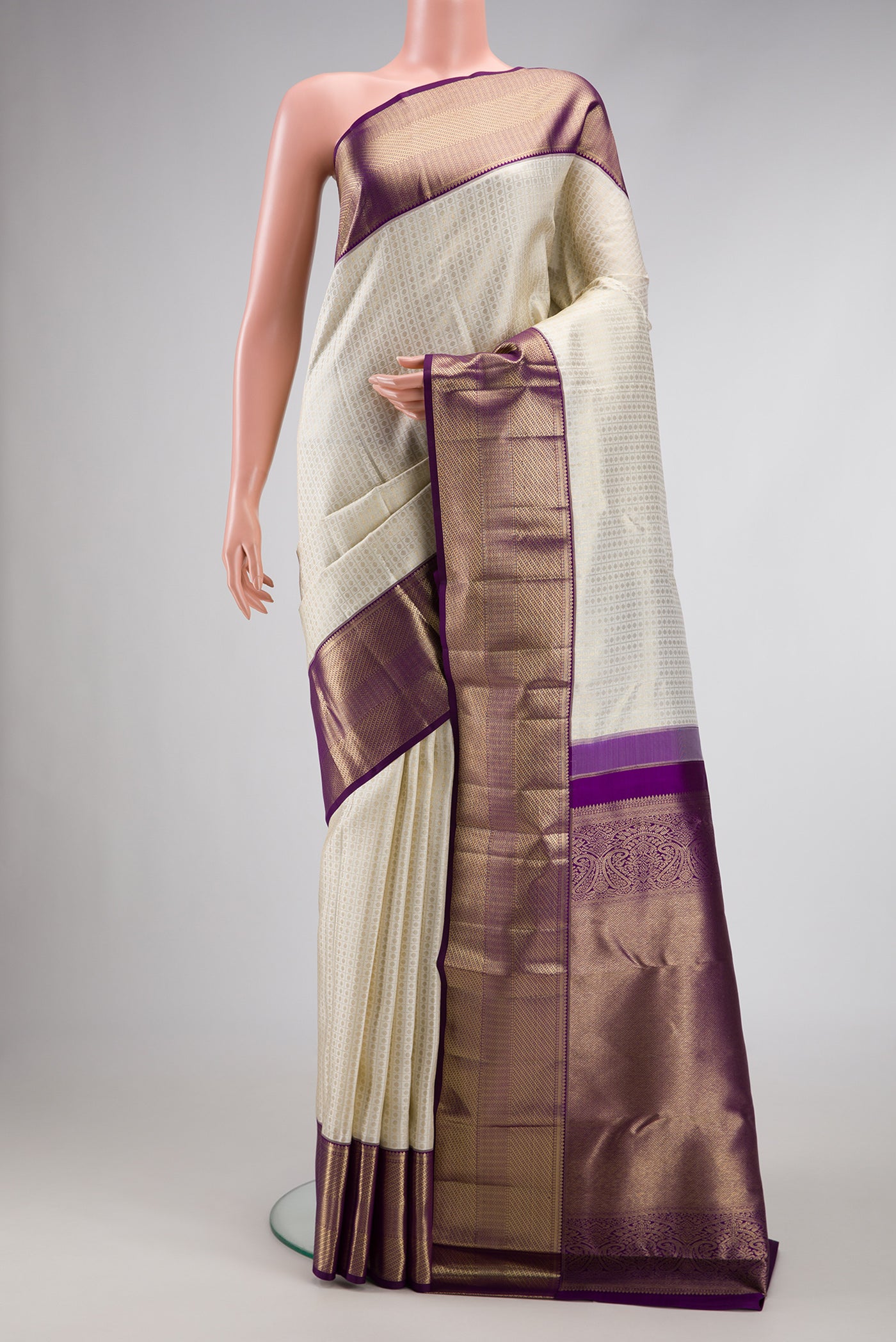 Off White Dual Tone Kanchipuram Silk Saree with Zari Brocade on the body and Zari Border.  displayed on a mannequin