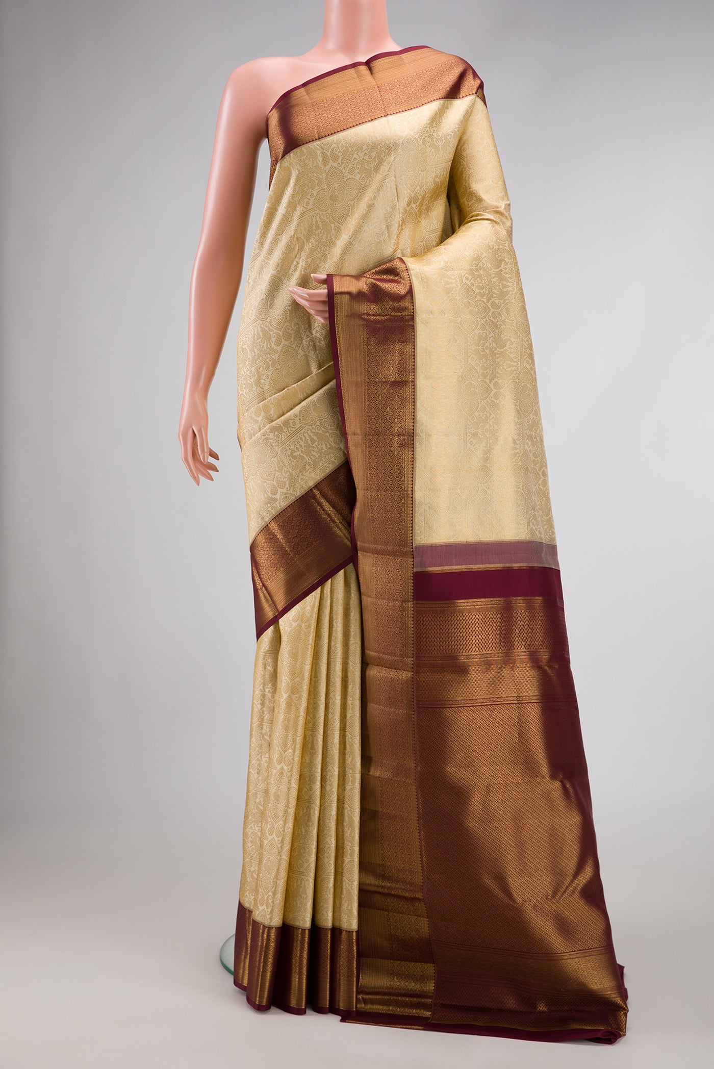 Gold Dual Tone Kanchipuram Silk Saree with Zari Brocade on the body and Zari Border.  displayed on a mannequin