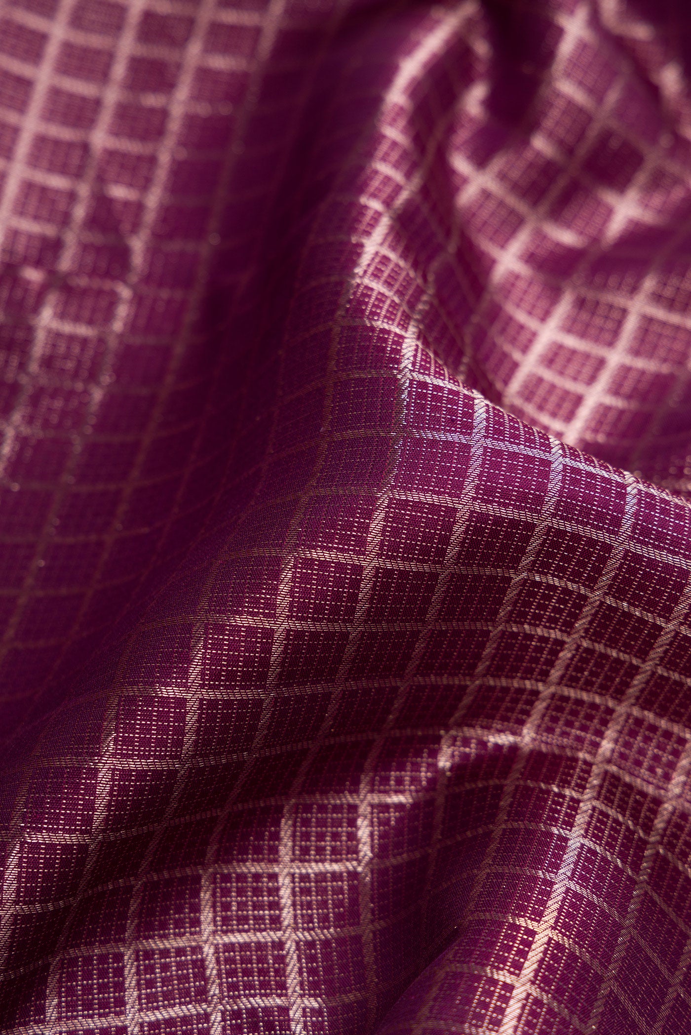 Close up of Burgundy Dual Tone Kanchipuram Silk Saree with Zari Brocade on the body and Zari Border.  displaying folds