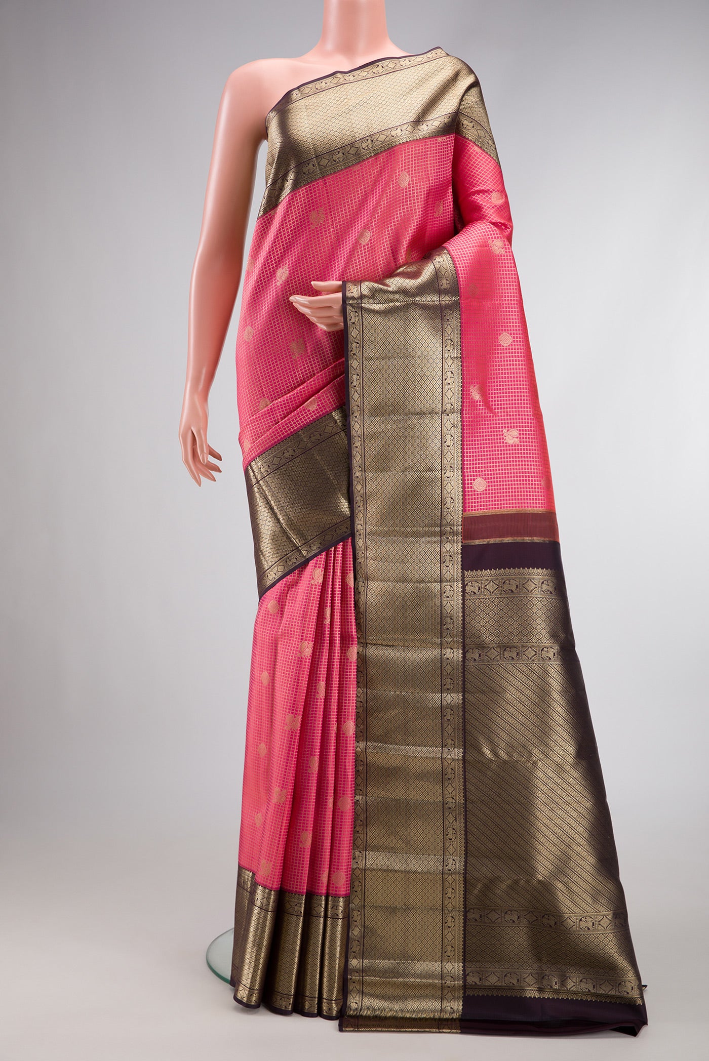 Pink Dual Tone Kanchipuram Silk Saree with Checked design on the body and Zari Border.  displayed on a mannequin