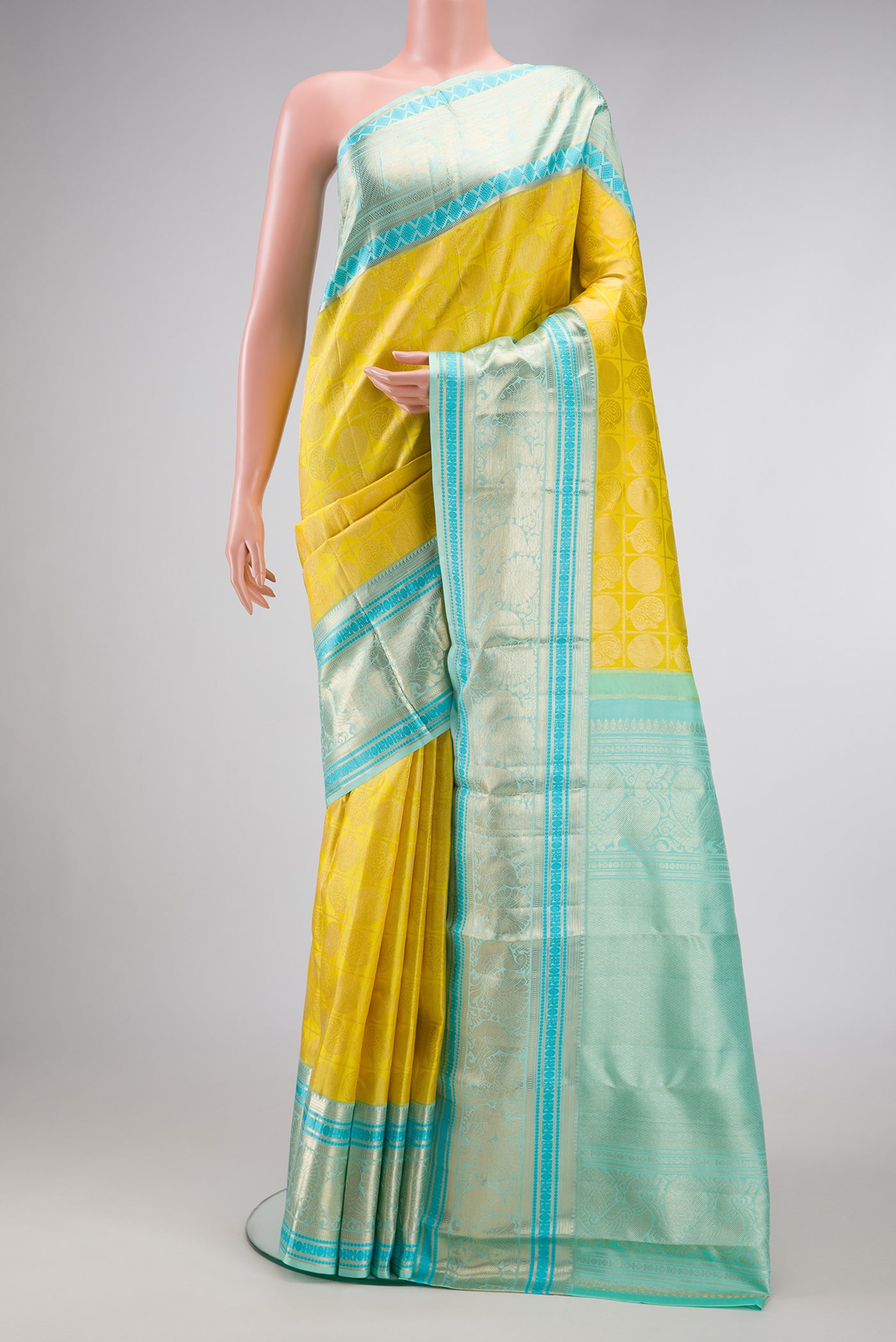 Yellow Dual Tone Kanchipuram Silk Saree with Zari Brocade on the body and Zari Border.  displayed on a mannequin