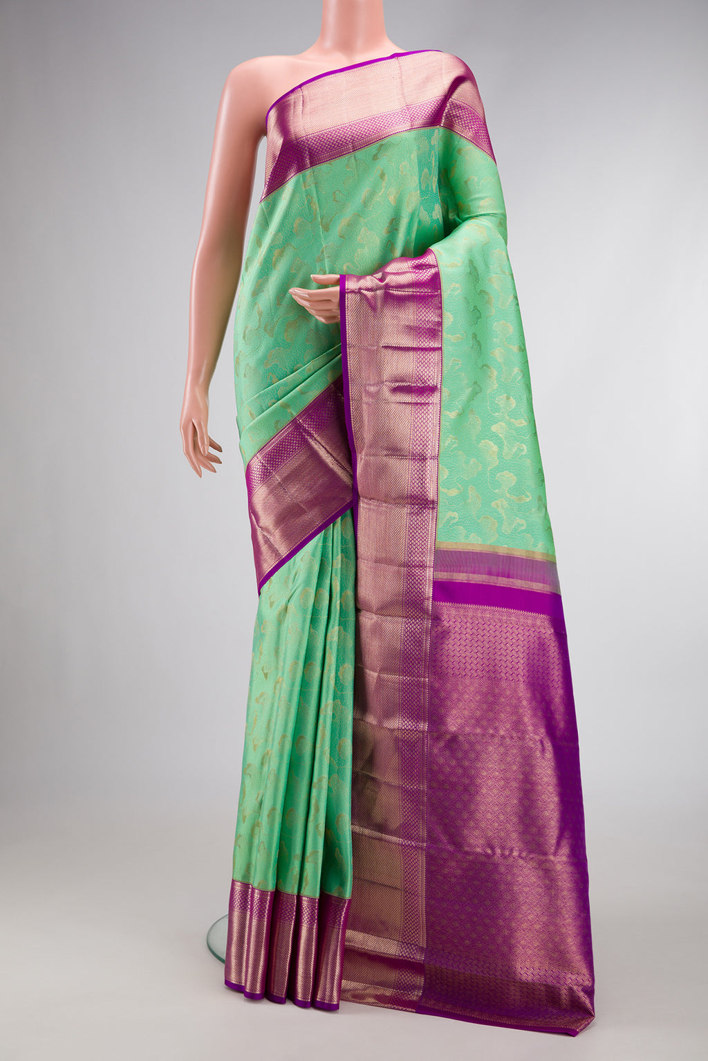 Sea Green Dual Tone Kanchipuram Silk Saree with Zari Brocade on the body and Zari Border.  displayed on a mannequin