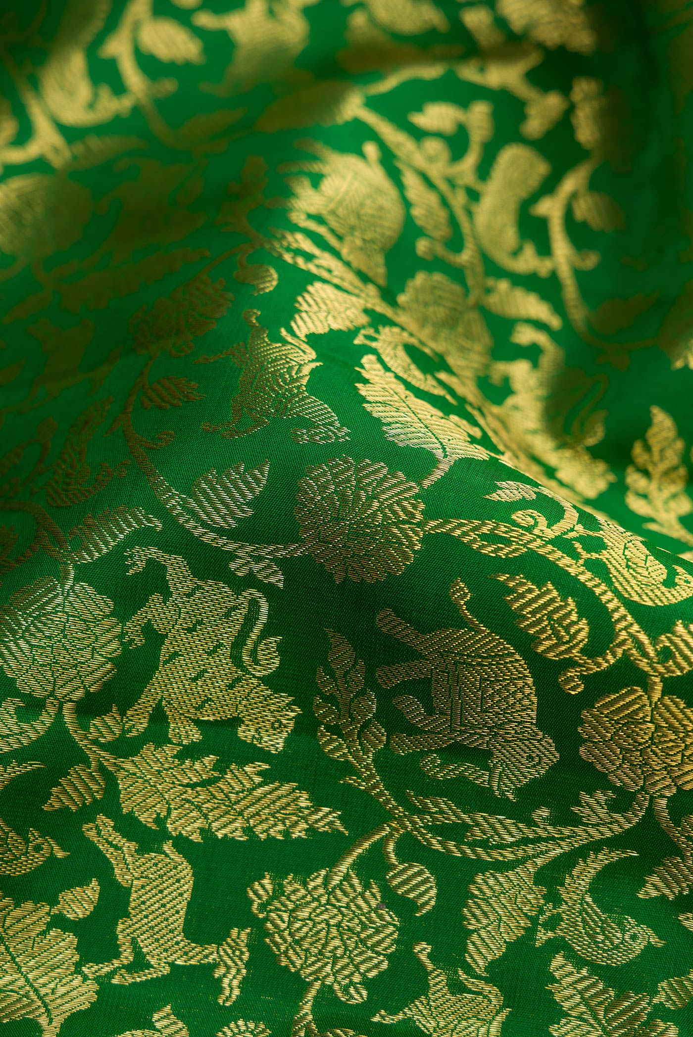 Close up of Bottle Green Dual Tone Kanchipuram Silk Saree with Zari Brocade on the body and Zari Border.  displaying folds
