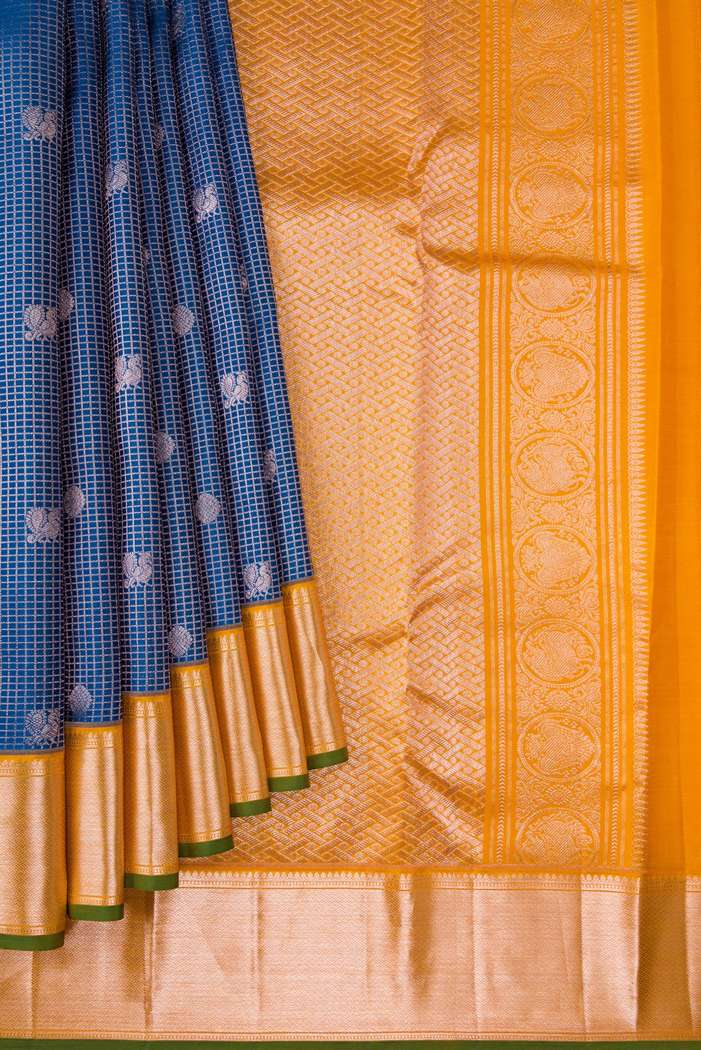 Pleats and pallu of Peacock Blue Dual Tone Kanchipuram Silk Saree with Zari Brocade on the body and Zari Border. 