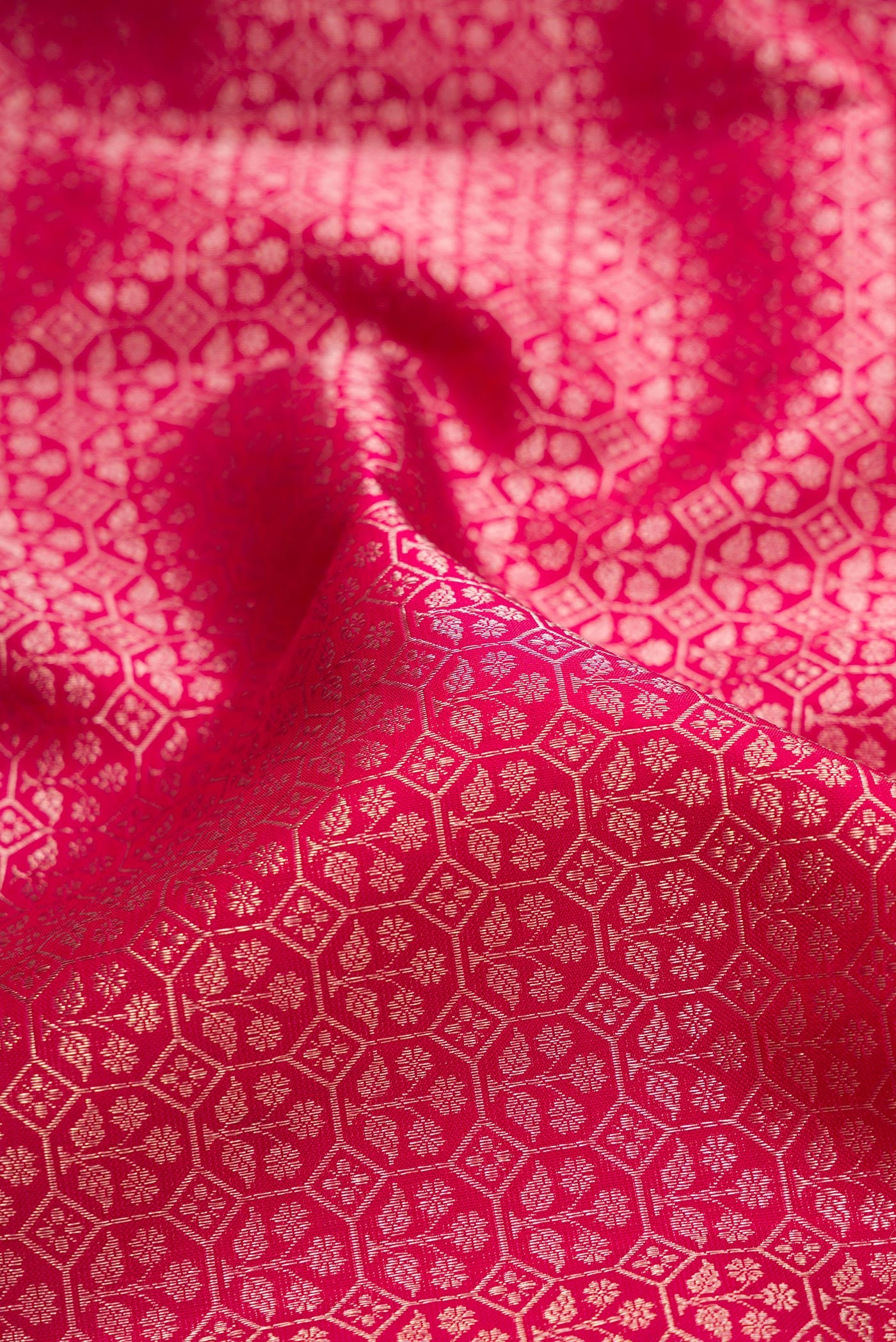 Close up of Dark Pink Kanchipuram Silk Saree with Zari Brocade on the body and Fancy Border.  displaying folds