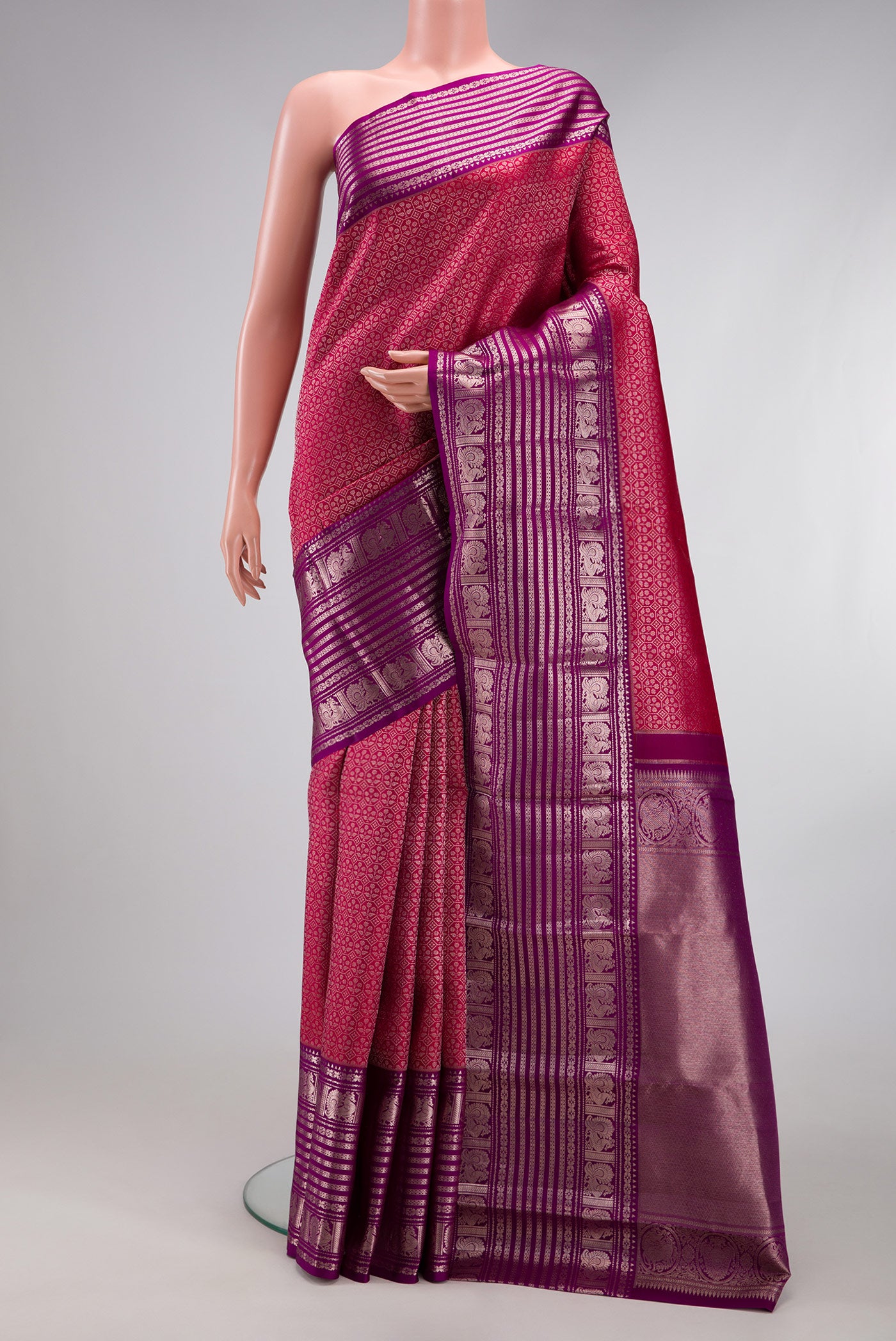Dark Pink Kanchipuram Silk Saree with Zari Brocade on the body and Fancy Border.  displayed on a mannequin