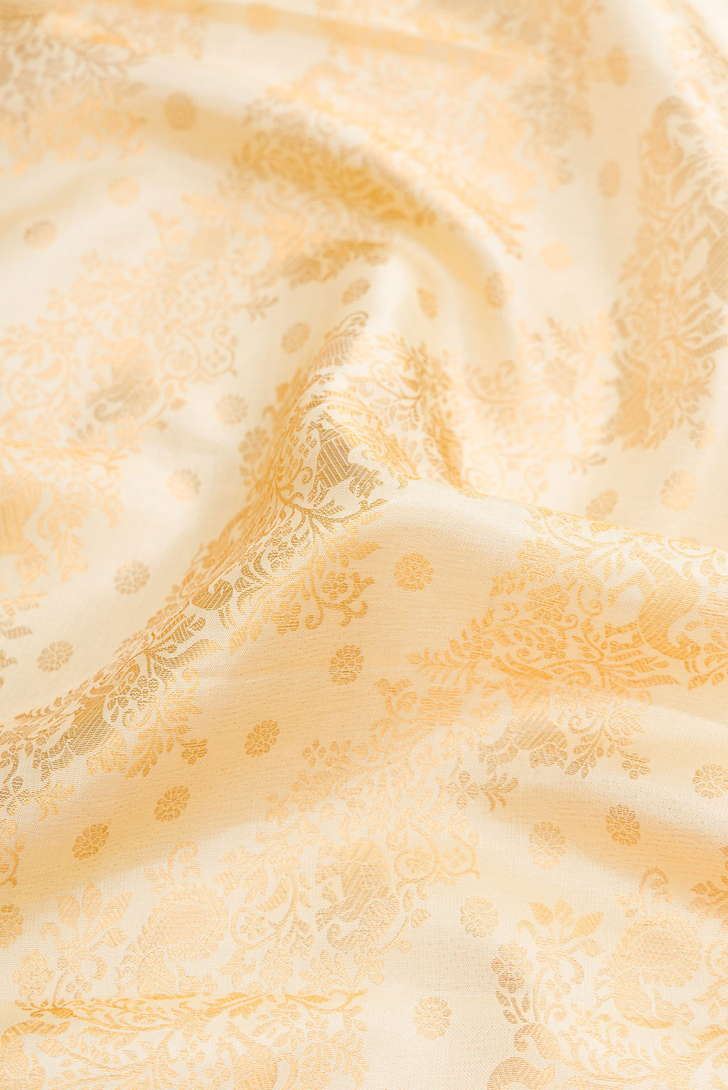 Close up of Off White Dual Tone Kanjivaram Silk Saree with Zari Brocade on the body and Zari Border.  displaying folds