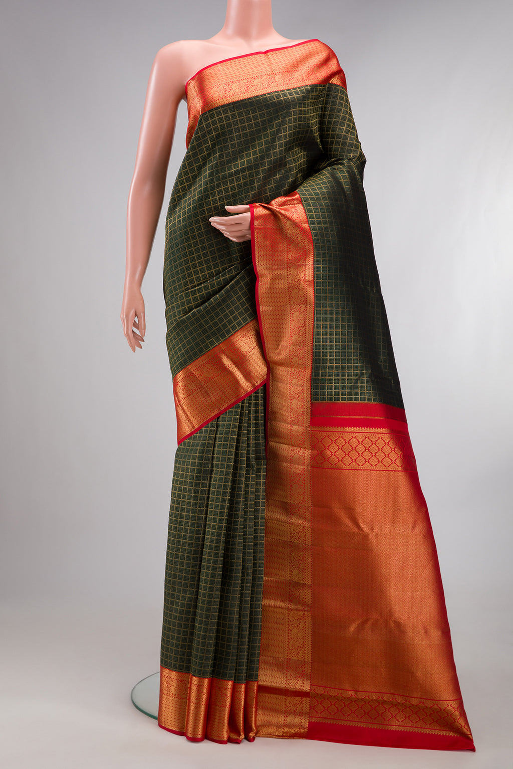 Pure Silk Bottle Green Kanjivaram Saree with Checked design on the body and Zari Border.  displayed on a mannequin