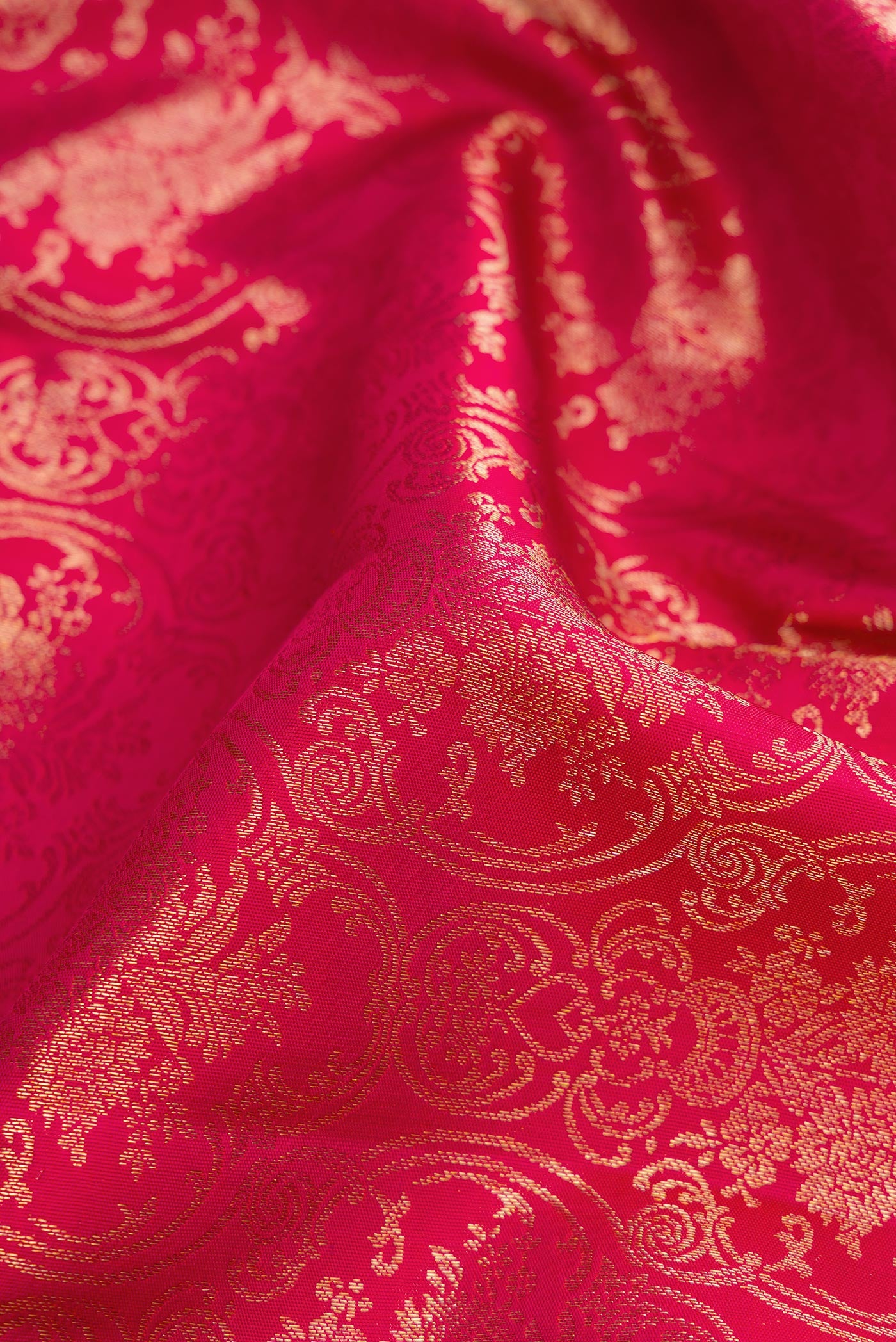 Close up of Pink Dual Tone Kanjivaram Silk Saree with Zari Brocade on the body and Zari Border.  displaying folds