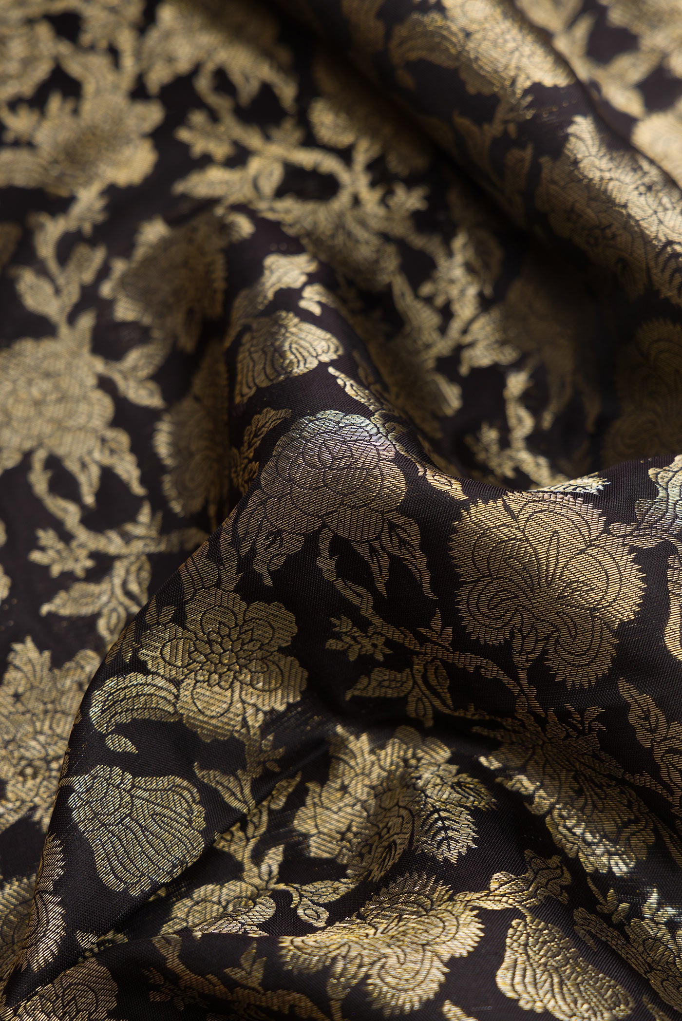 Close up of Black Dual Tone Kanjivaram Silk Saree with Zari Brocade on the body and Zari Border.  displaying folds