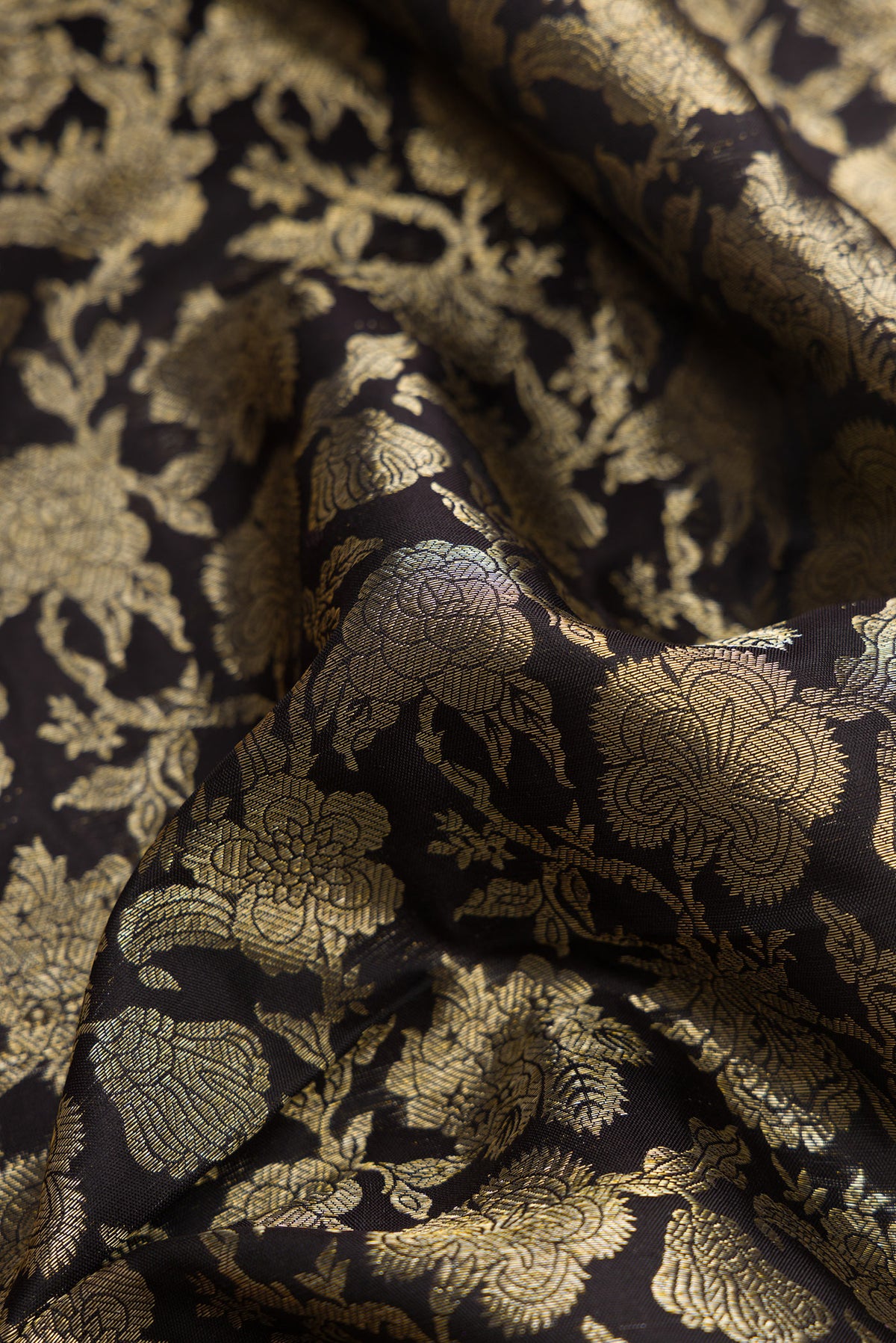 Close up of Black Dual Tone Kanjivaram Silk Saree with Zari Brocade on the body and Zari Border.  displaying folds