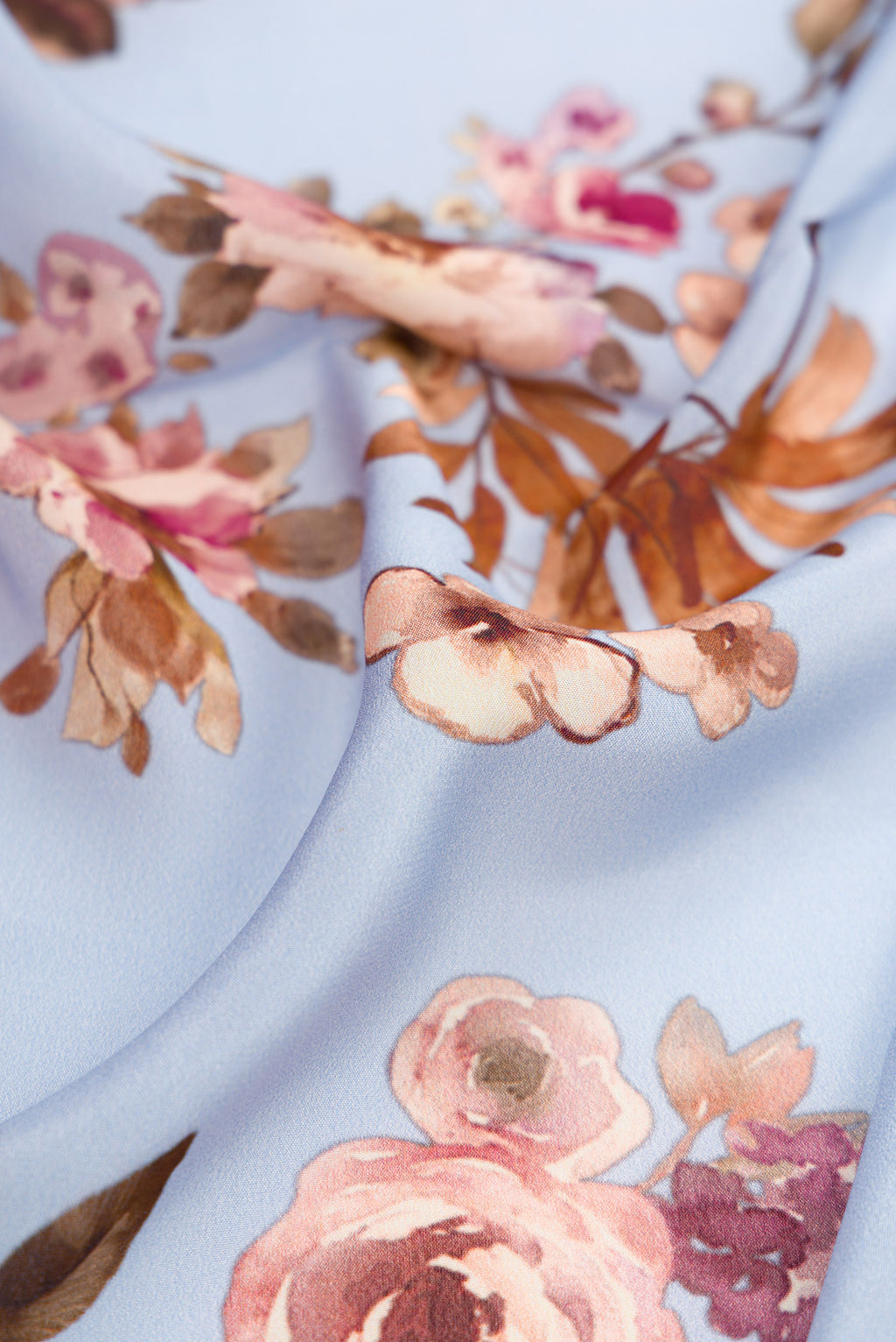 Close up of Light Blue Crepe Saree with Printed design on the body and Plain Border.  displaying folds