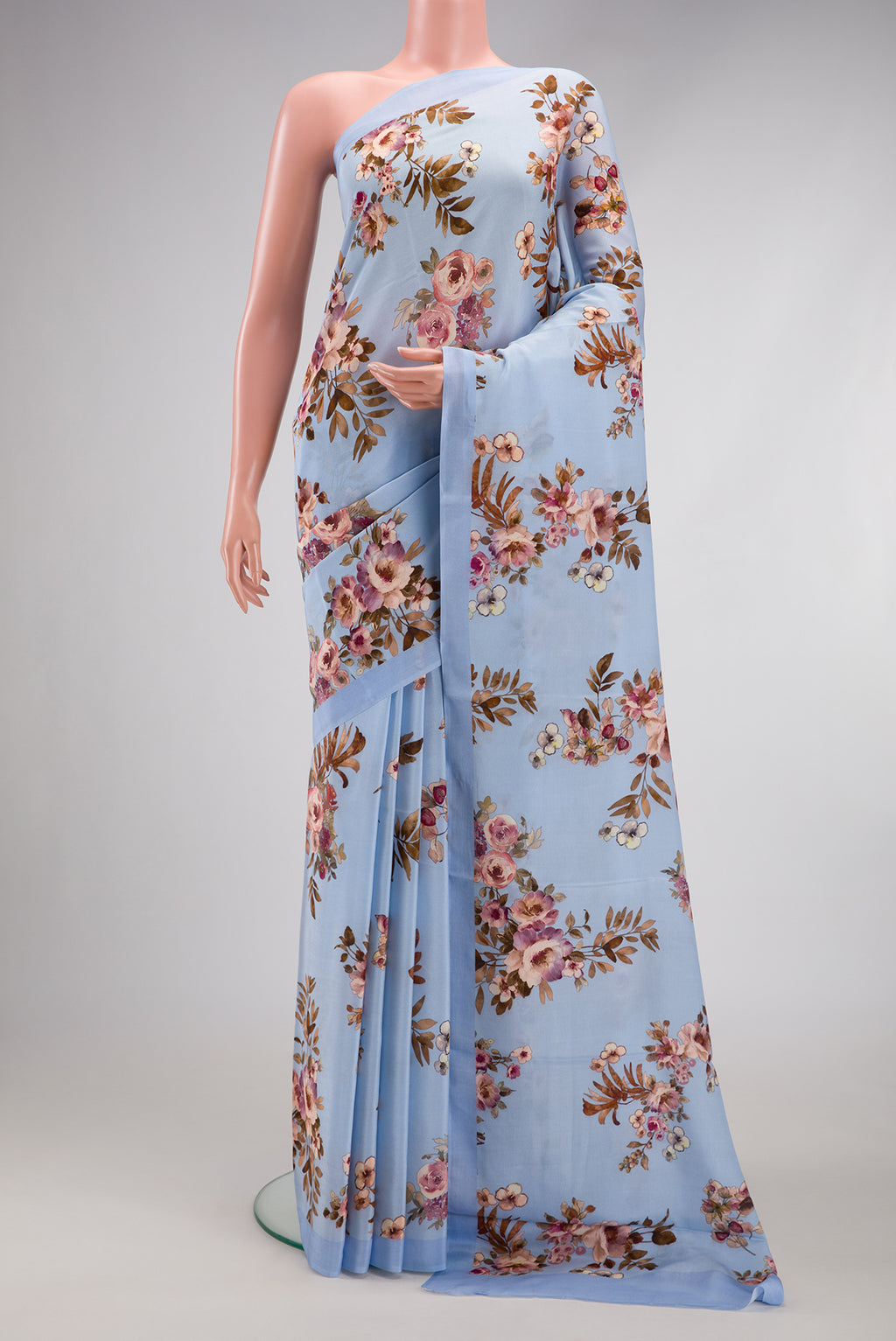 Light Blue Crepe Saree with Printed design on the body and Plain Border.  displayed on a mannequin