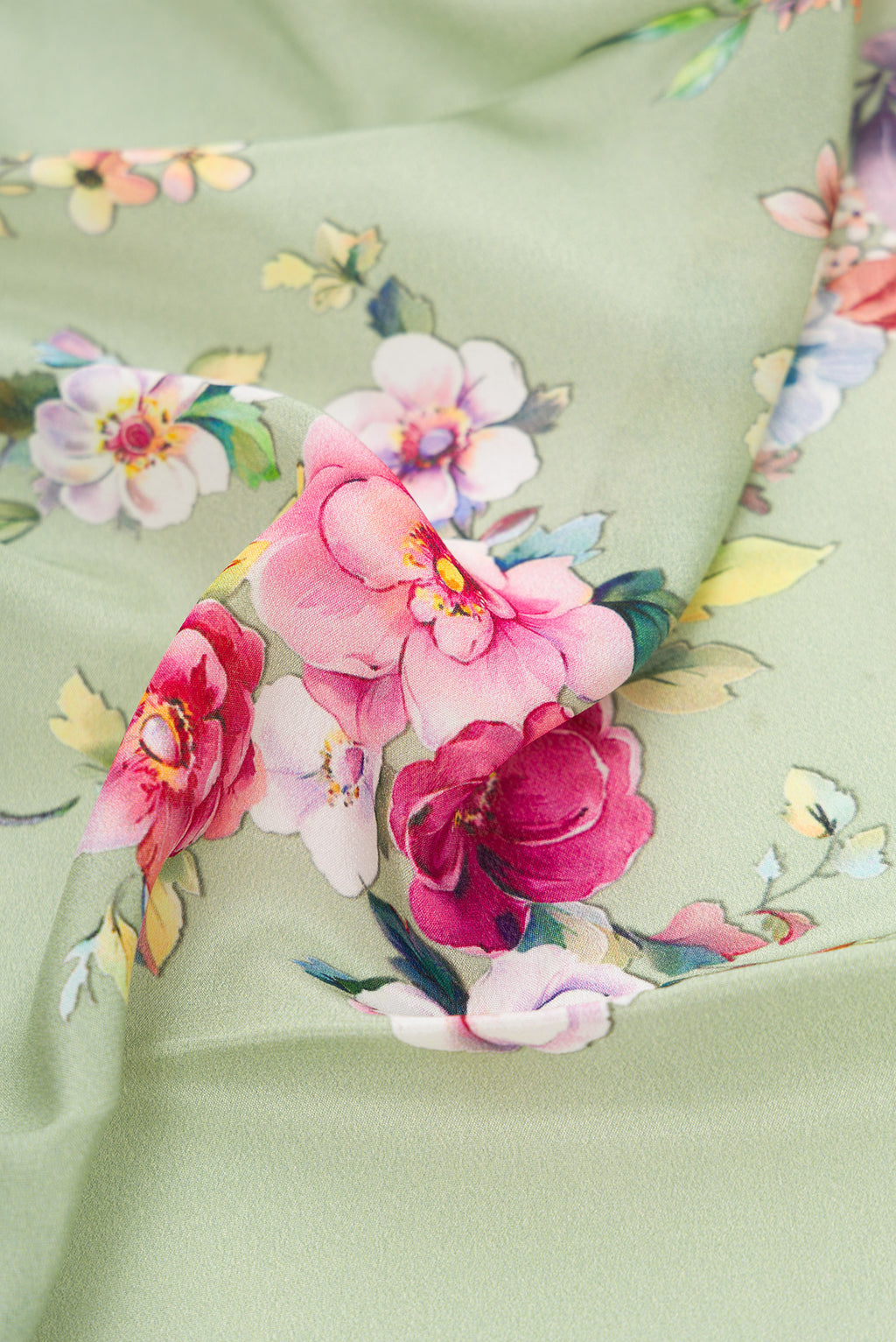 Close up of Pista Green Dual Tone Mysore Crepe Saree with Printed design on the body and Plain Border.  displaying folds