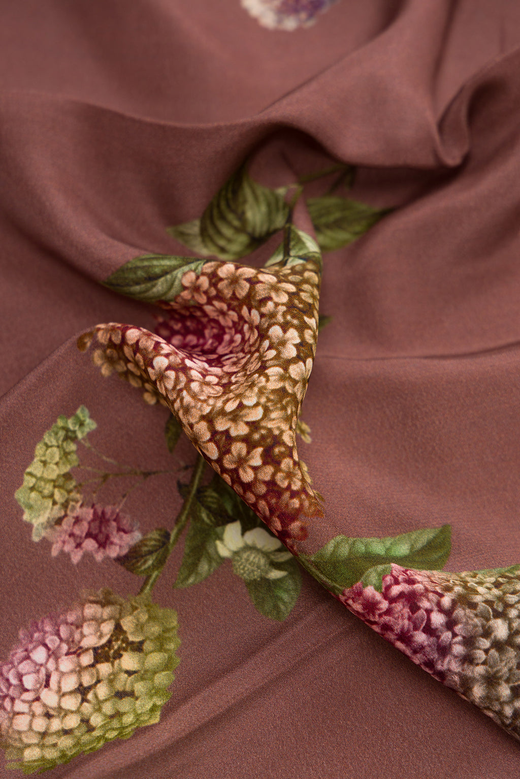 Close up of Brown Dual Tone Mysore Crepe Saree with Printed design on the body and Plain Border.  displaying folds
