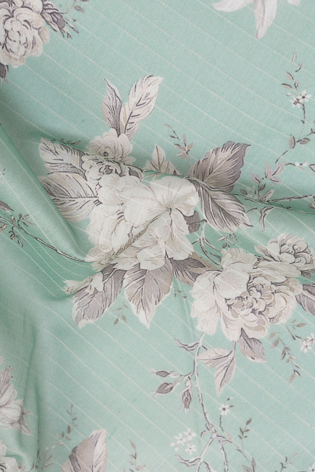 Close up of Pure Silk Sea Green Dual Tone Chanderi Saree with Printed design on the body and Zari Border.  displaying folds