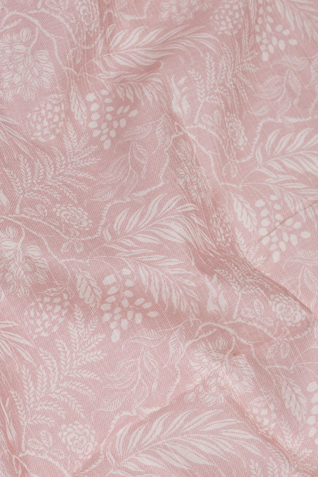 Close up of Rose Gold Dual Tone Chanderi Silk Saree with Printed design on the body and Zari Border.  displaying folds