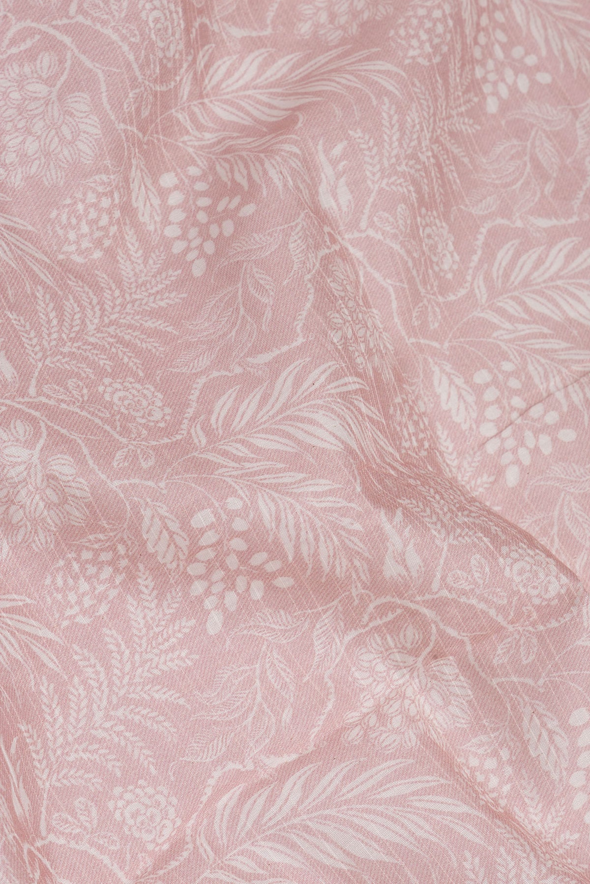 Close up of Rose Gold Dual Tone Chanderi Silk Saree with Printed design on the body and Zari Border.  displaying folds